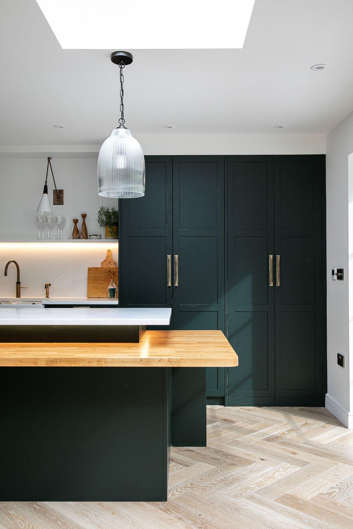 A spacious and functional Westward Ho kitchen with ample storage solutions, including a corner larder with Norfolk bar handles, generous cabinets, and a large island.