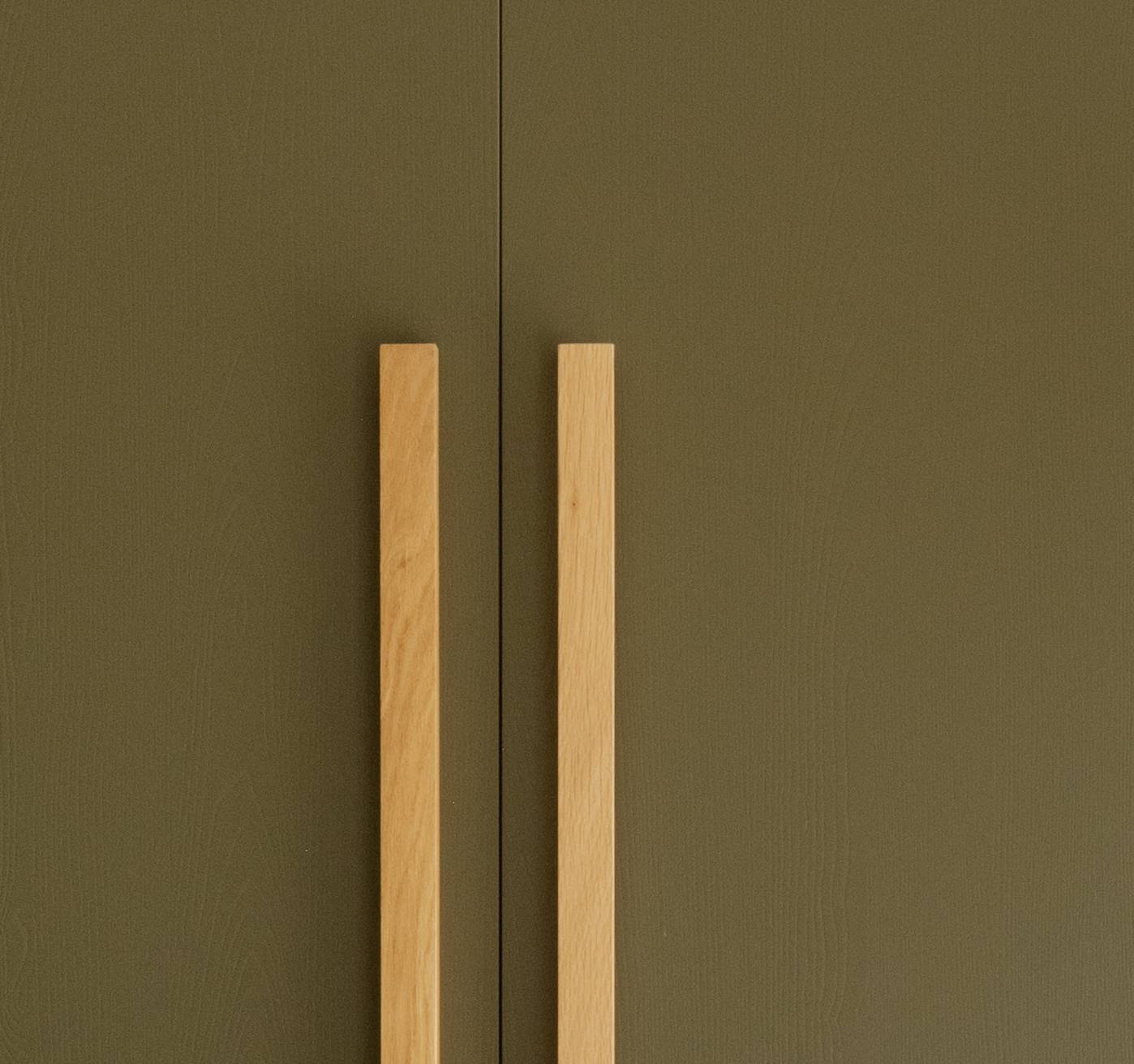A close-up of a bar handle in oak.