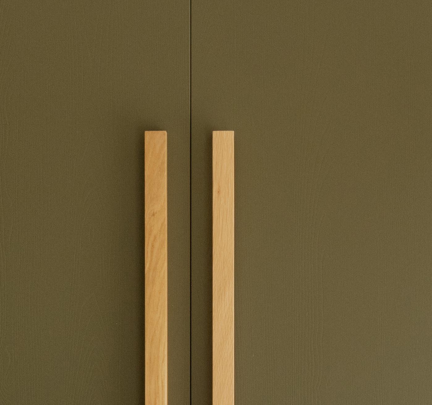 A close-up of a bar handle in oak.
