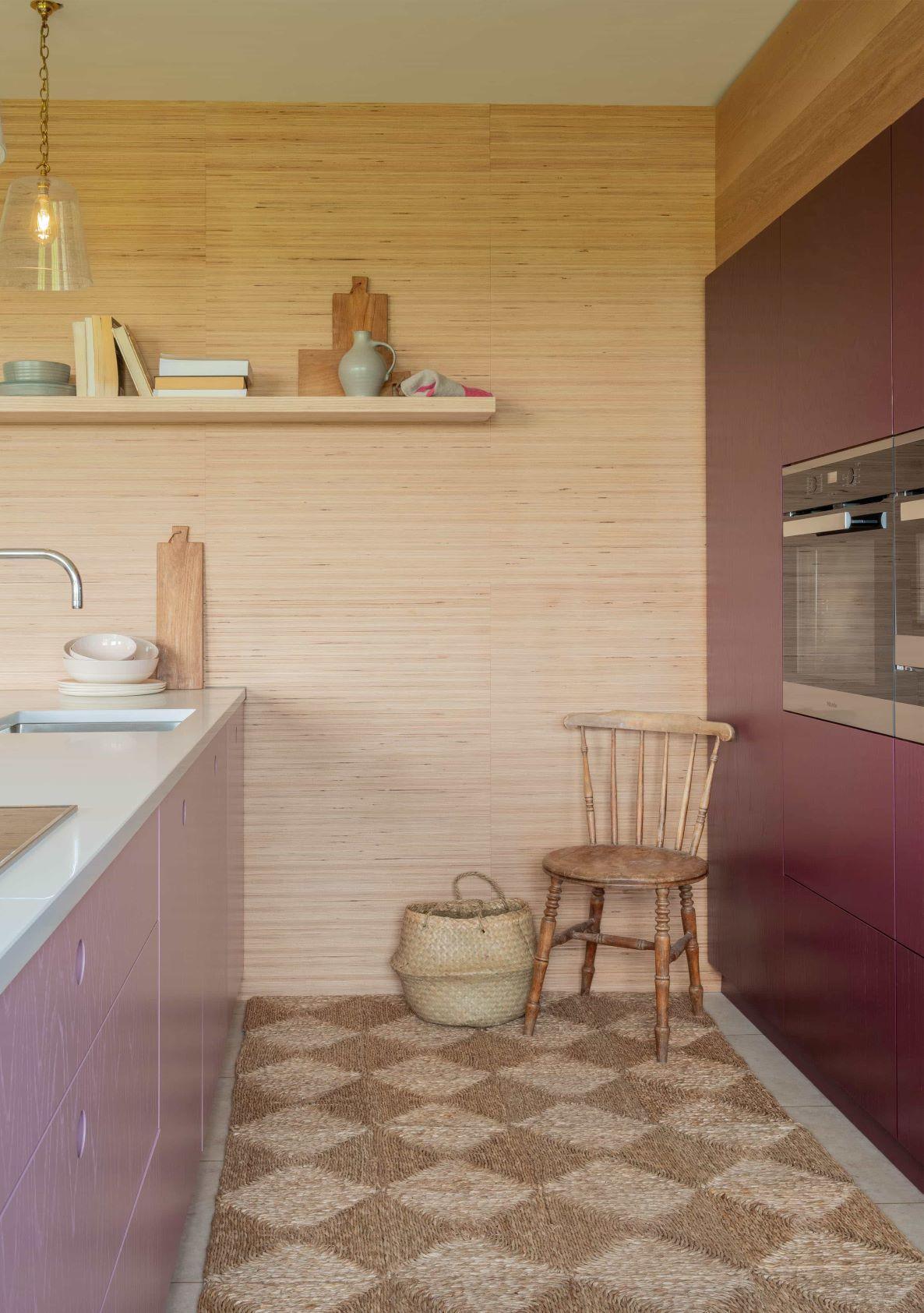 Bold pink & purple Ladbroke doors & cabinetry create a vibrant & playful statement, complemented by Miele appliances & waterfall white worktops.