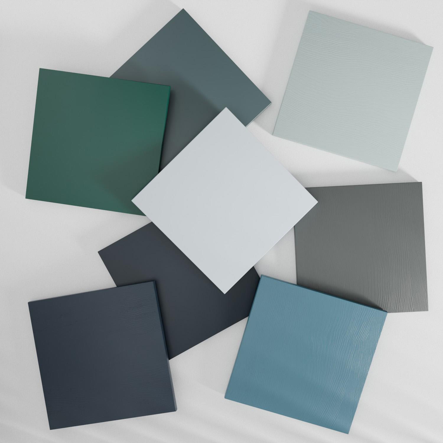 Eight square tiles in various shades of blue are arranged in an overlapping circular pattern on a light background. The tiles have a matte finish, with subtle textures visible on some surfaces.