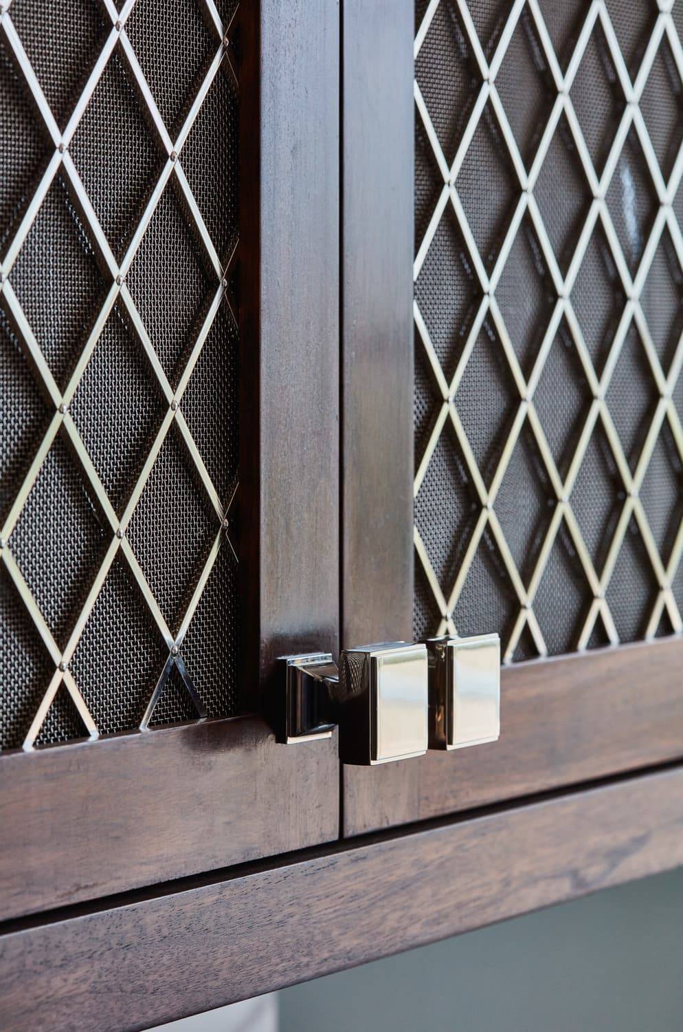 A detailed view of the Georgian Hall kitchen's cabinets reveals the intricate grain of the walnut wood, adding depth and character to the overall design