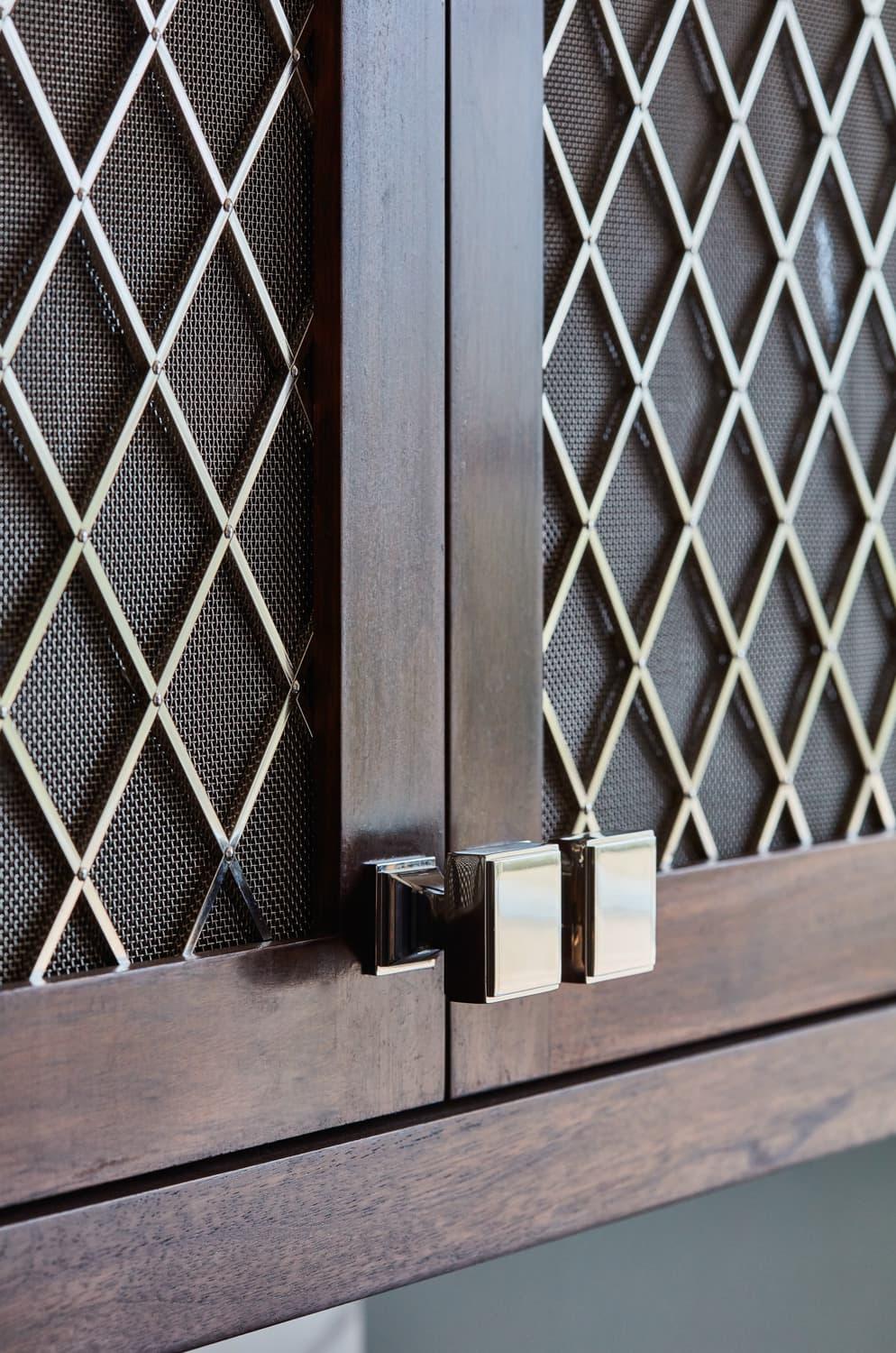 A detailed view of the Georgian Hall kitchen's cabinets reveals the intricate grain of the walnut wood, adding depth and character to the overall design