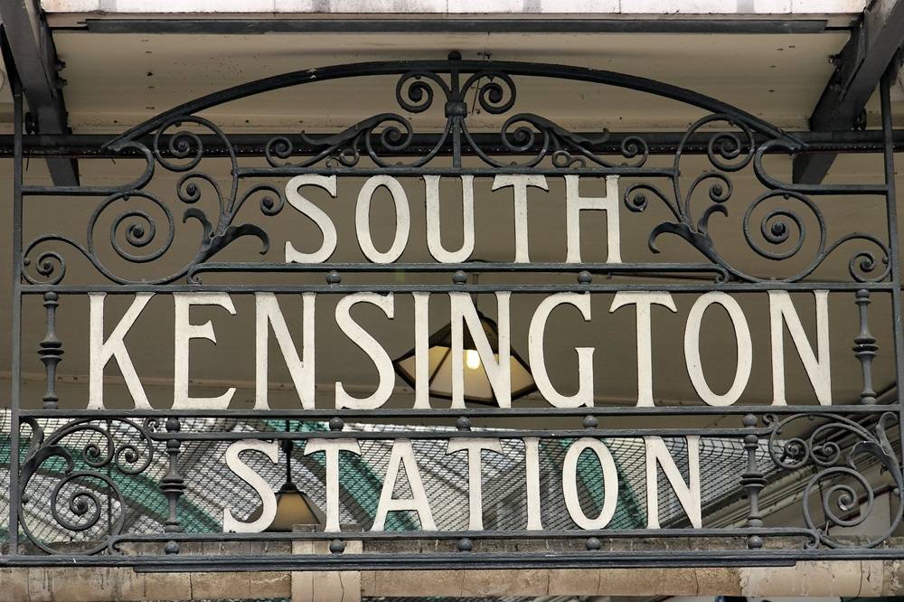Traditional metal sign saying South Kensington Station