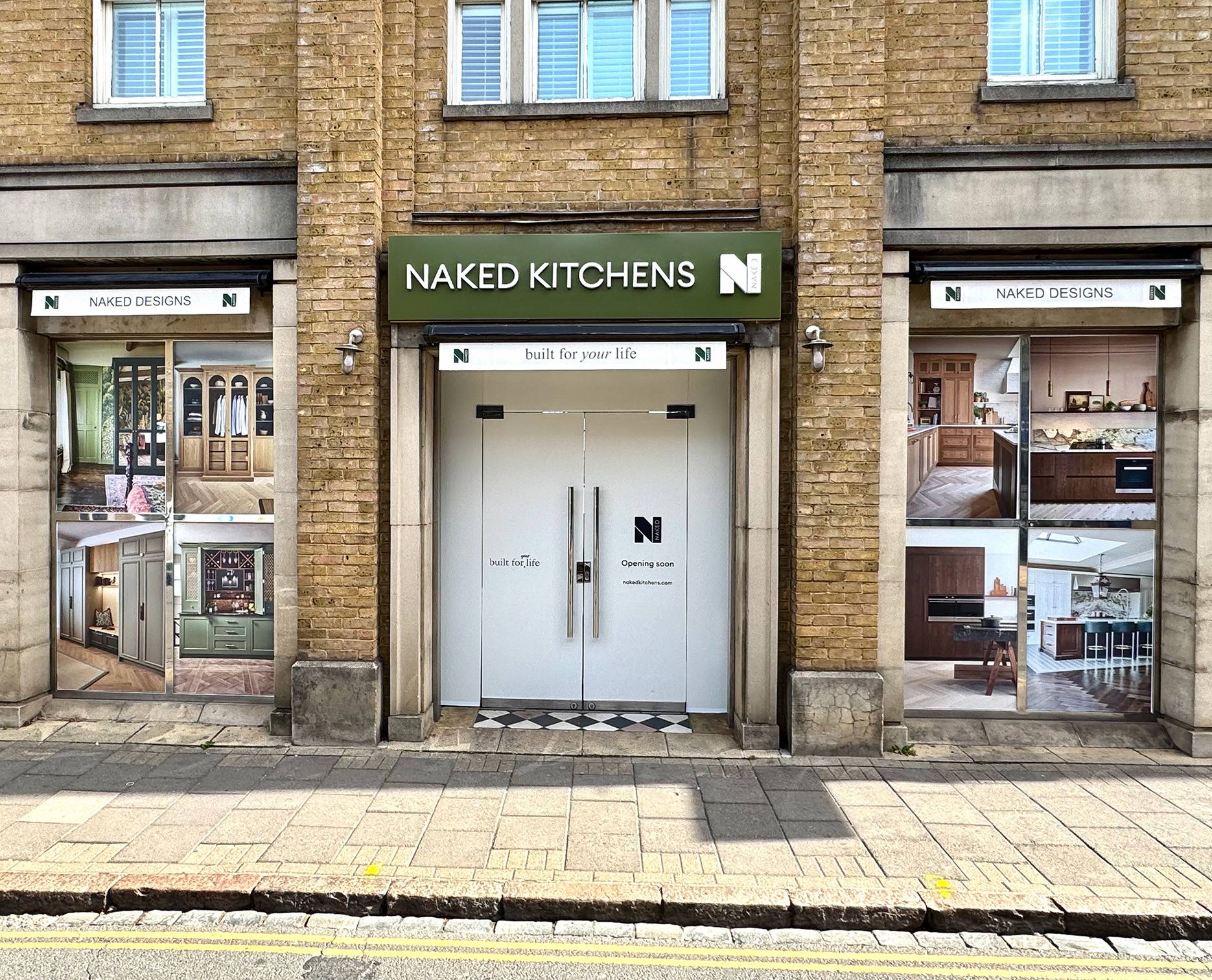 front entrance to Cambridge showroom. Green sign with white text above glass double doors.