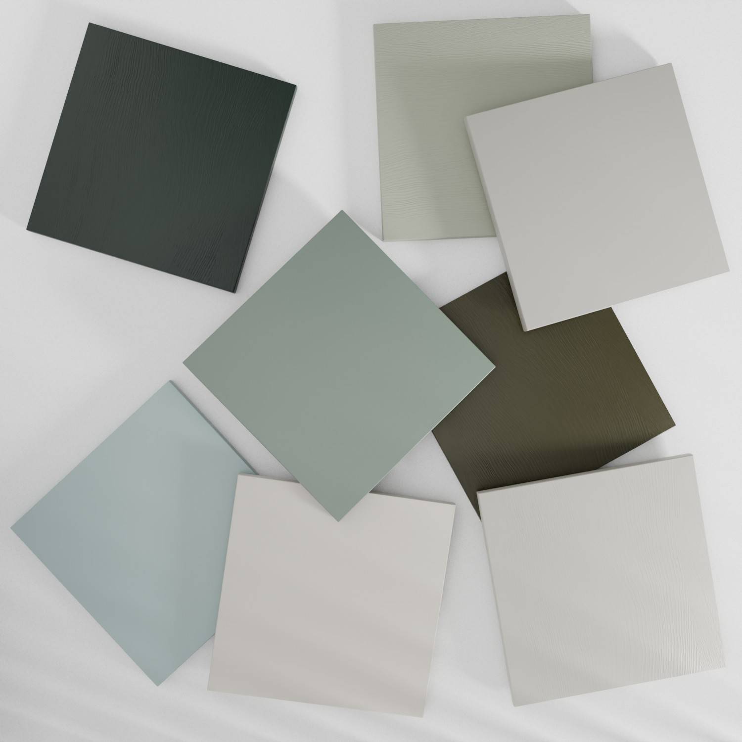 Eight square tiles arranged on a light surface. The tiles vary in color, including shades of green, beige, and brown. They are placed in a loose, overlapping pattern.