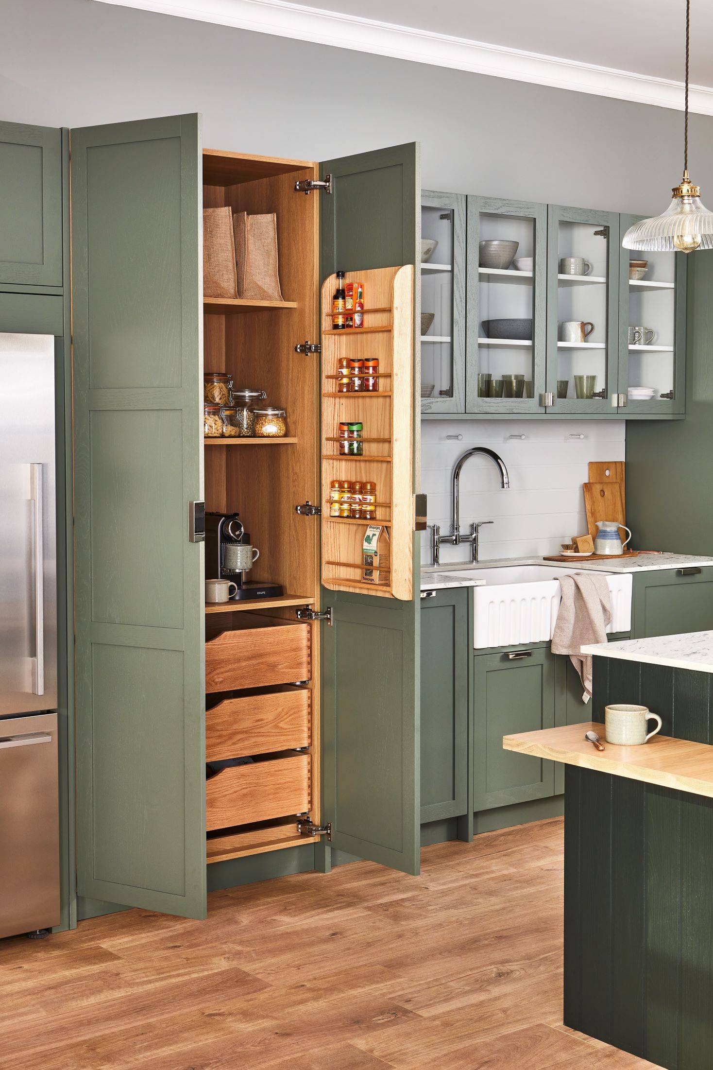 A captivating glimpse into the kitchen's larder, a hidden treasure trove for storing and displaying culinary treasures. The larder's ample shelving and glass doors allow for easy access and elegant presentation of food items