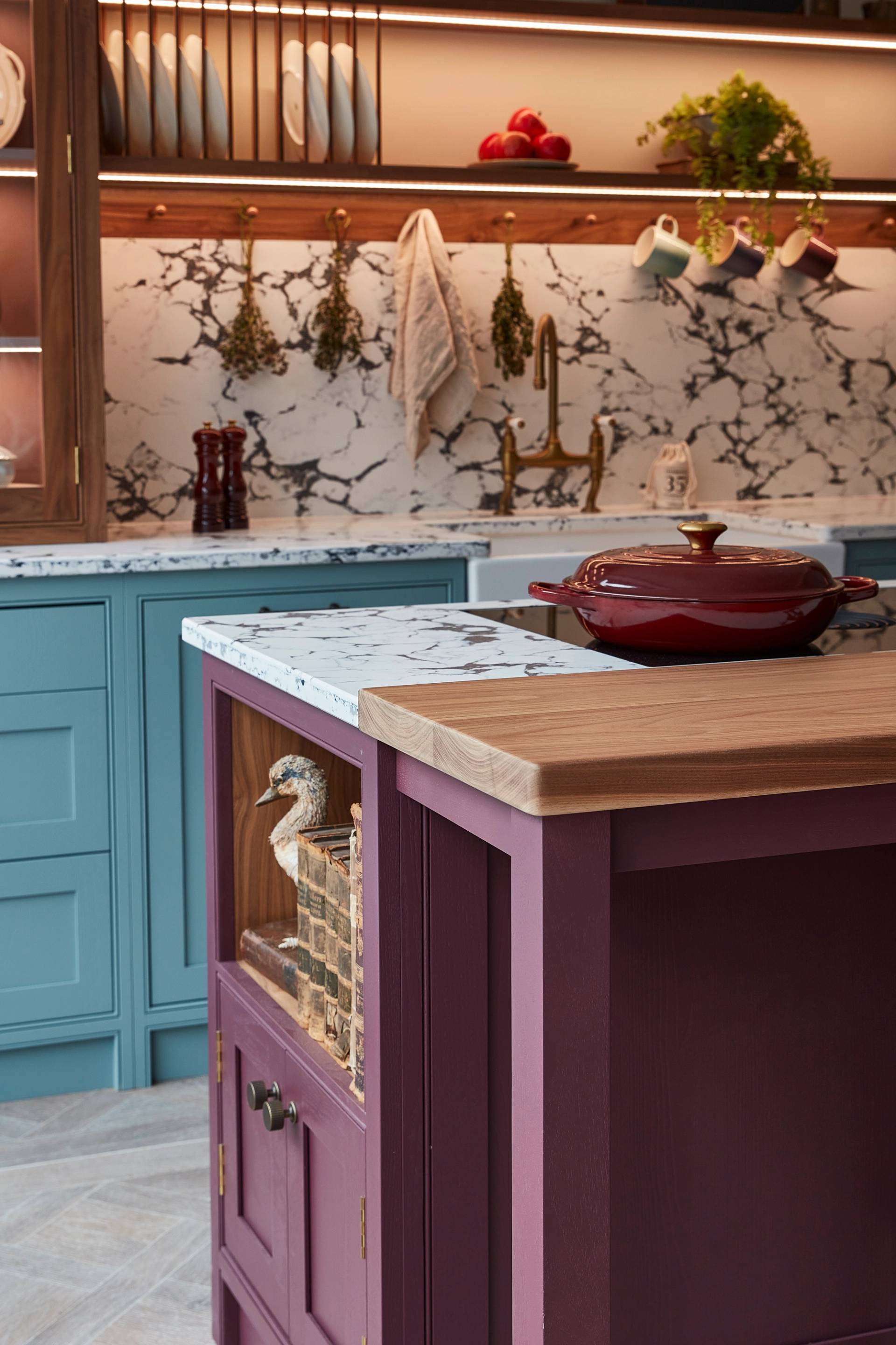 dark blue ladbroke handleless kitchen with red backings