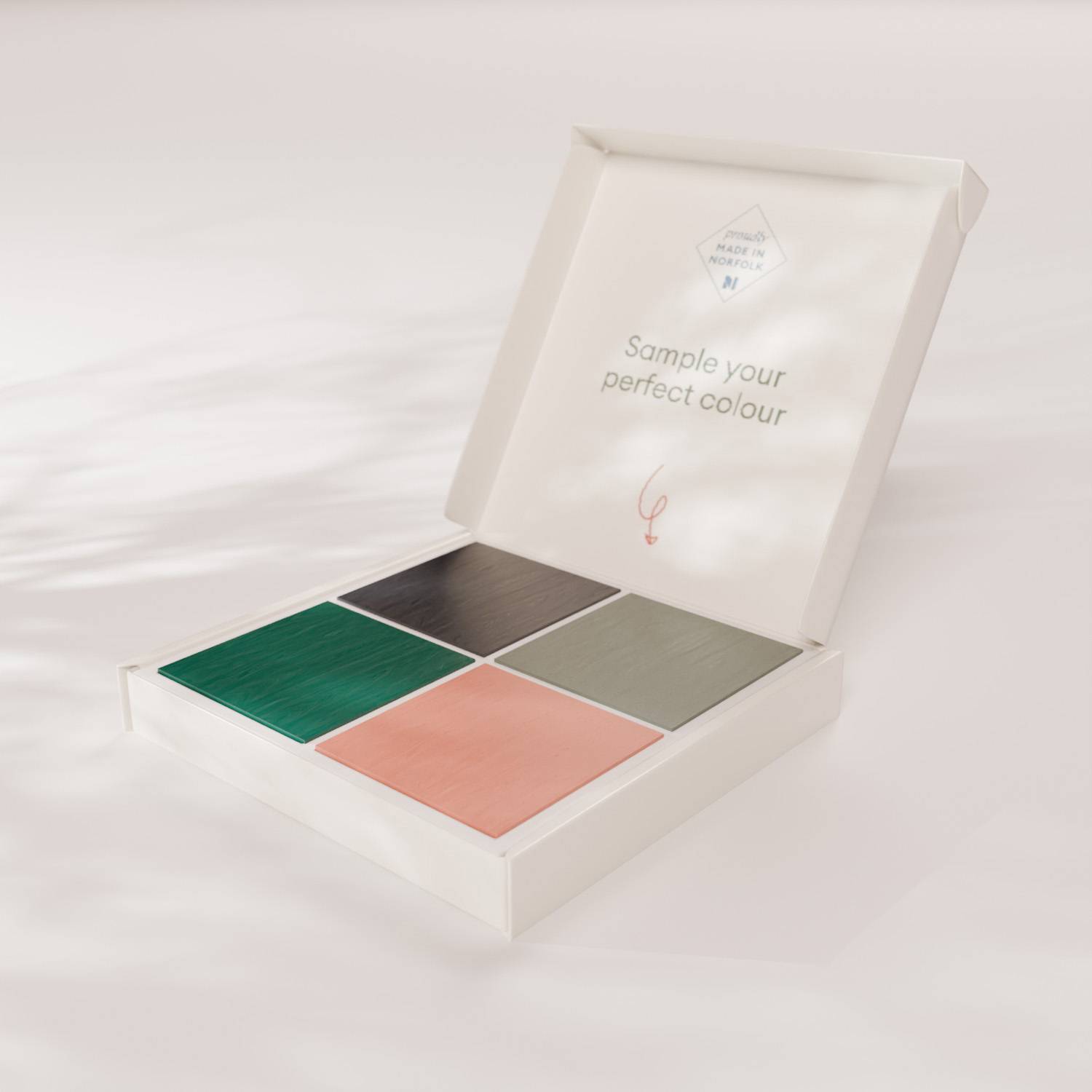 Open sample box with four square paint shades