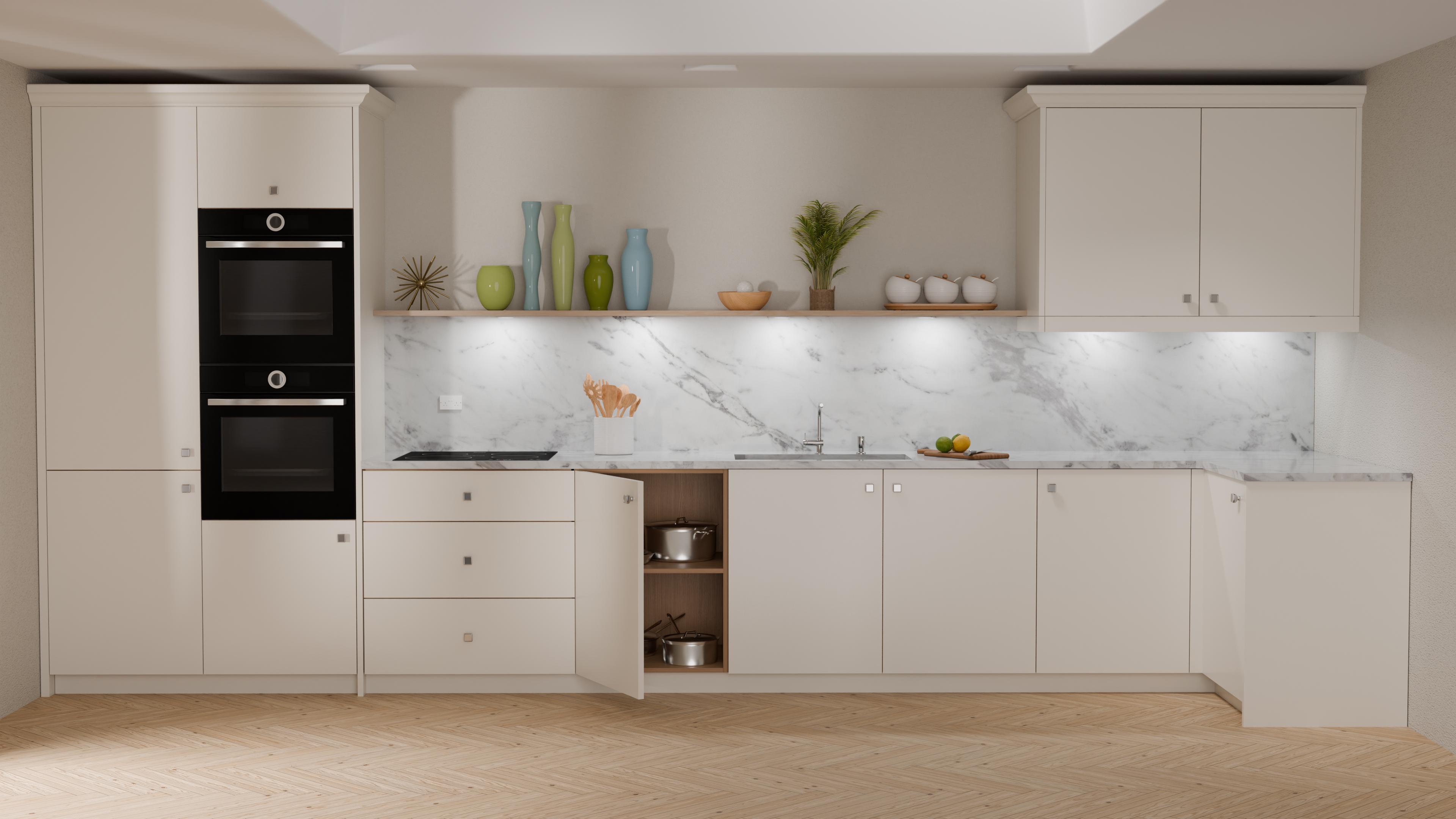 A modern kitchen with white cabinets and a marble backsplash. It features a built-in double oven, light wood flooring, and various decorative items like vases, a plant, fruit, and stacked bowls on the counters. Some cabinet doors are open.