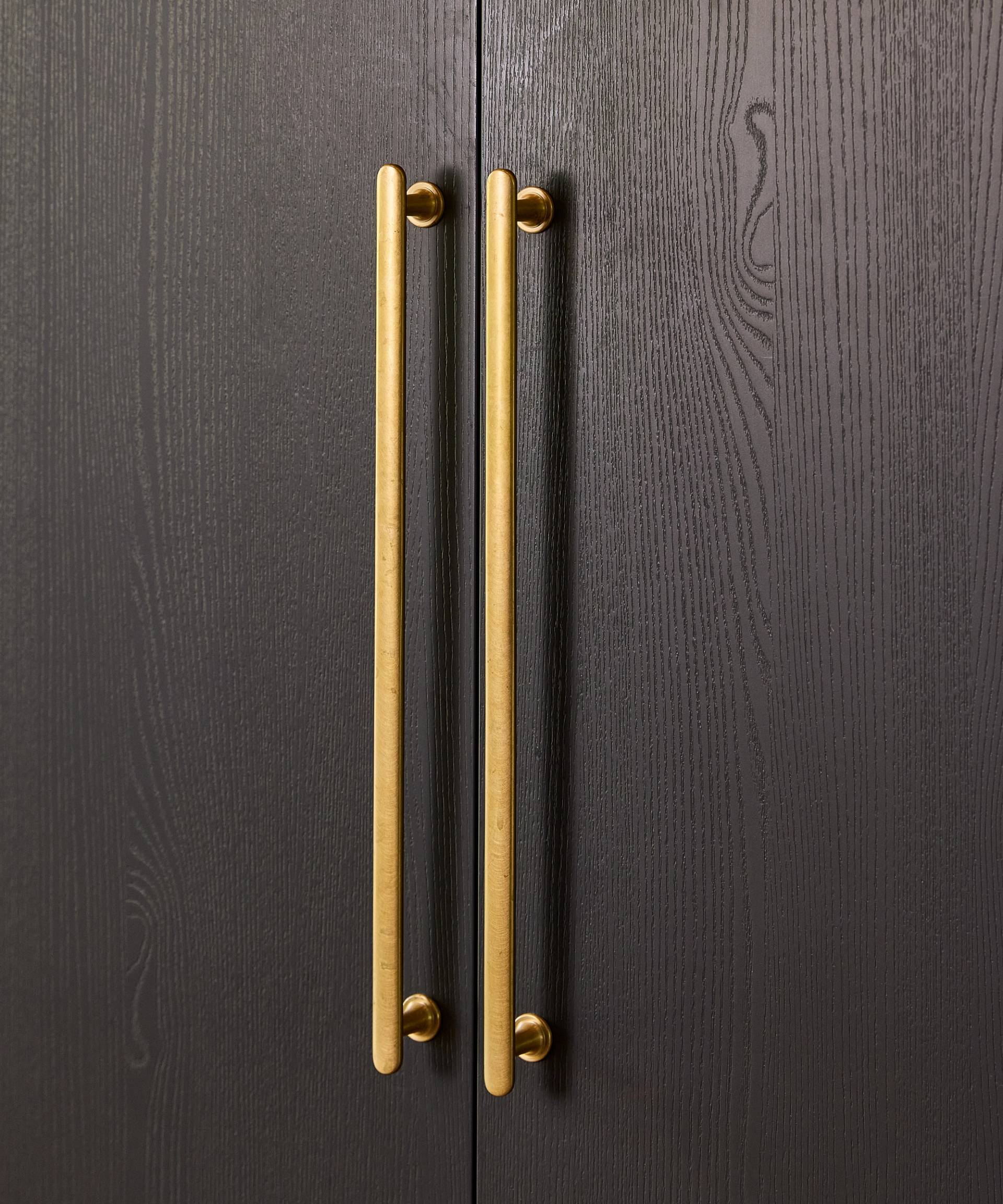 Close-up of a slab door with vertical handles.