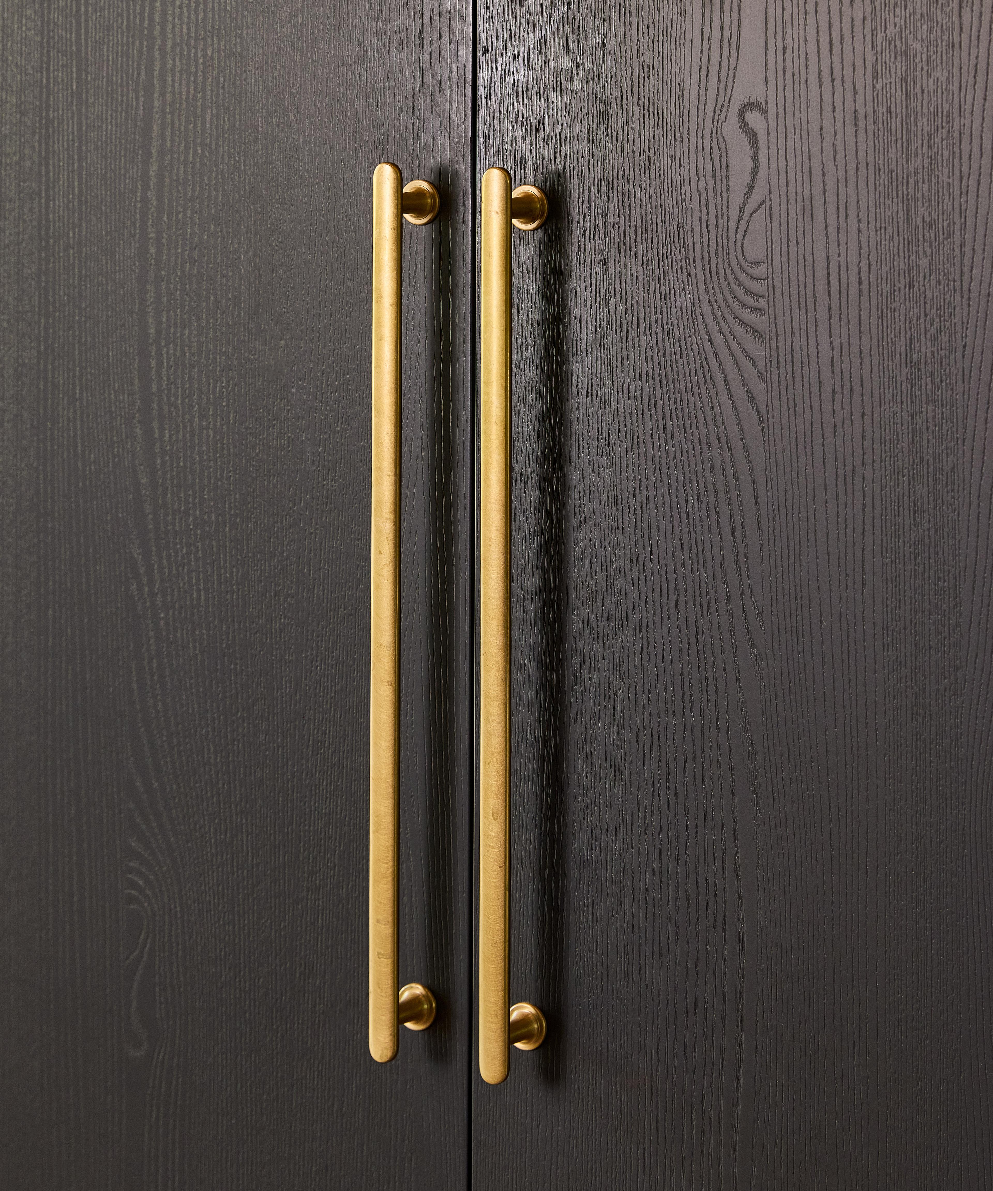 Close-up of a slab door with vertical handles.