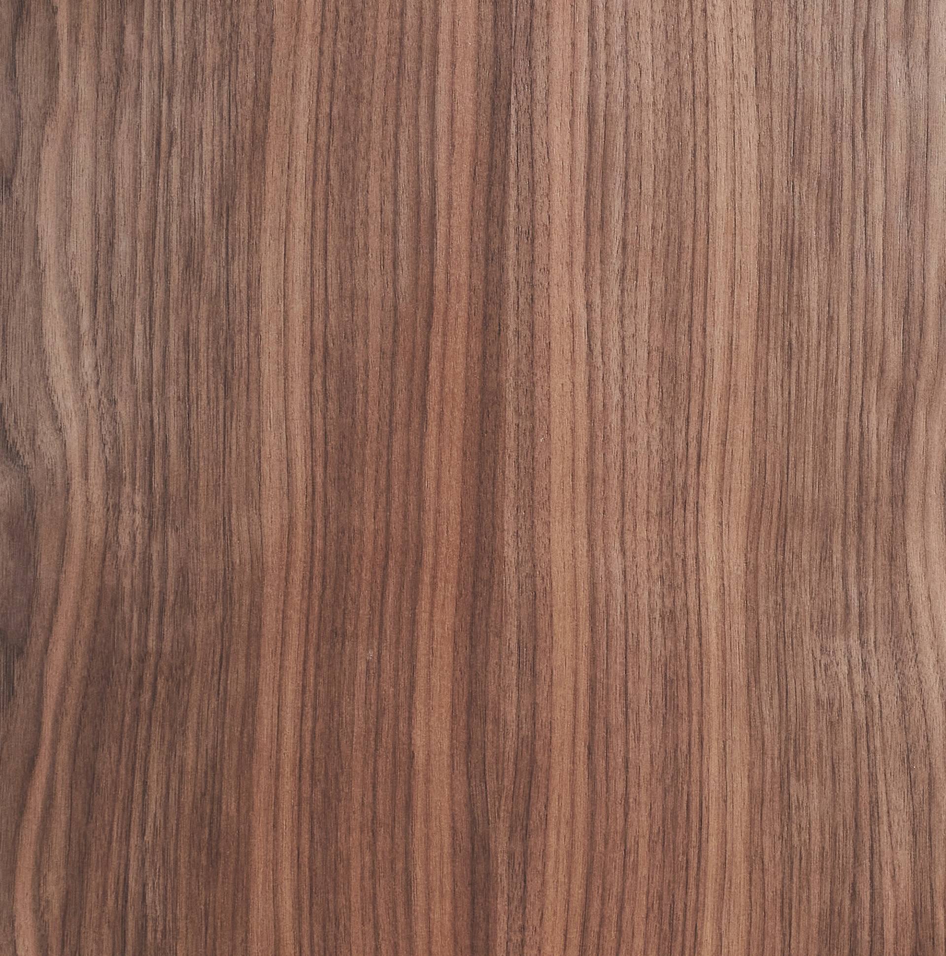 Wooden surface with a smooth, natural grain pattern. The woods color varies from light to dark brown, with vertical, wavy lines creating an organic texture. The surface appears polished and consistent across the image