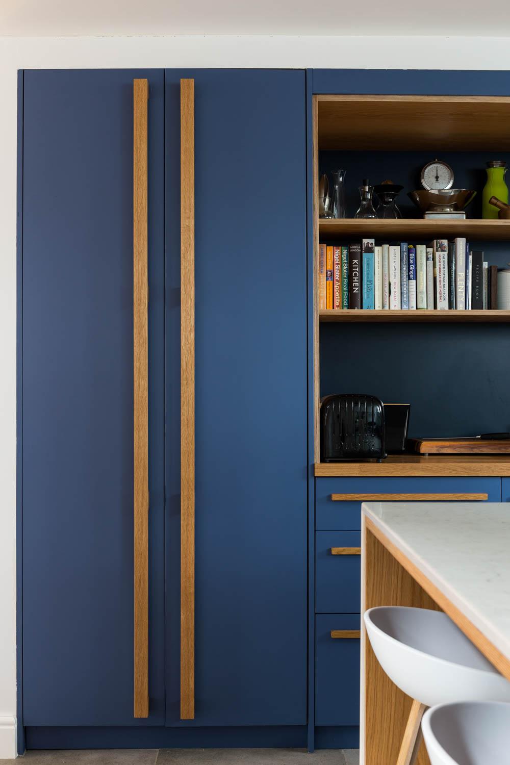 Open shelving showcases essential cookware, injecting a hint of individual style and personality into the minimalist space.