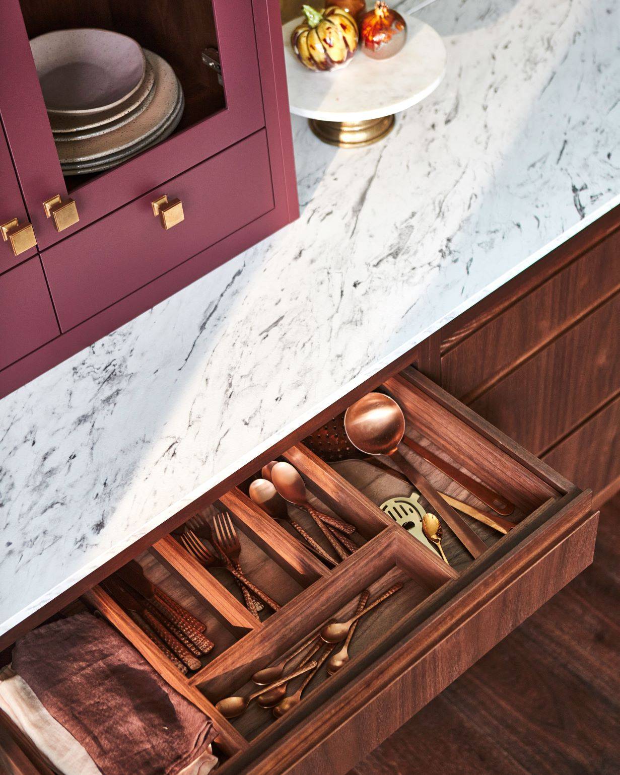 Delve into a hidden treasure trove of culinary delights, where the kitchen's stunning larder basks in rich purple hue and features ample shelving for storage and display. This larder provides a haven for storing and showcasing your pantry staples.