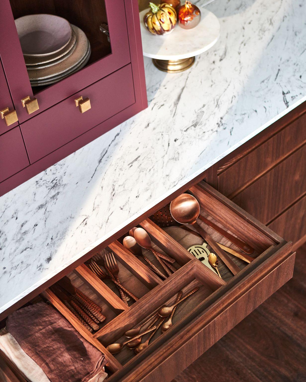 Delve into a hidden treasure trove of culinary delights, where the kitchen's stunning larder basks in rich purple hue and features ample shelving for storage and display. This larder provides a haven for storing and showcasing your pantry staples.