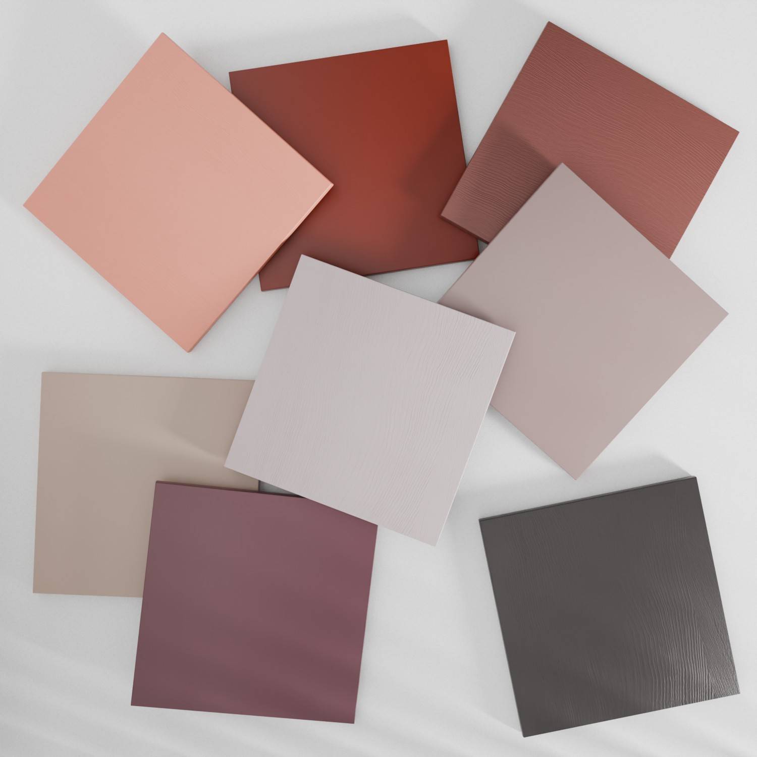 Eight square tiles arranged in a circular pattern on a light surface. The tiles vary in shades of pink, and red, each with a subtle texture.