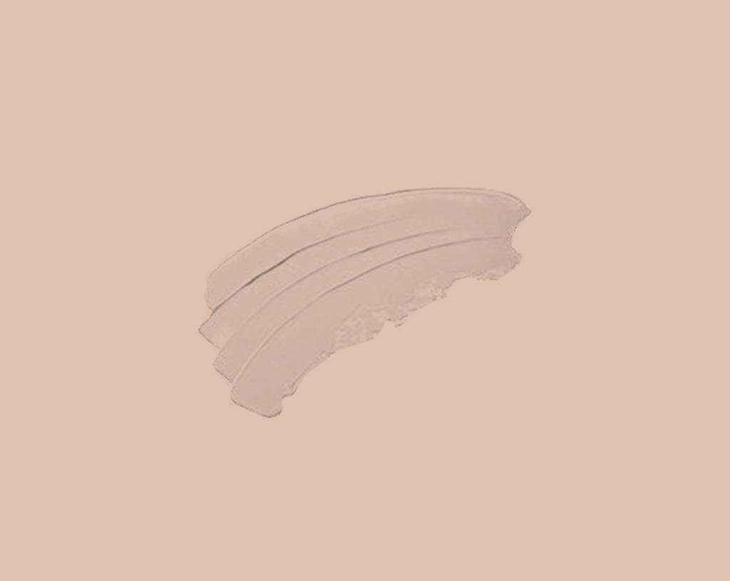 Three smooth, curved swipes of a creamy, beige cosmetic product are spread on a solid light peach background.