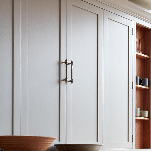 Light-colored cabinets with metal handles are next to open wooden shelves displaying mugs and small bowls. Two larger wooden bowls are partially visible at the bottom of the image.