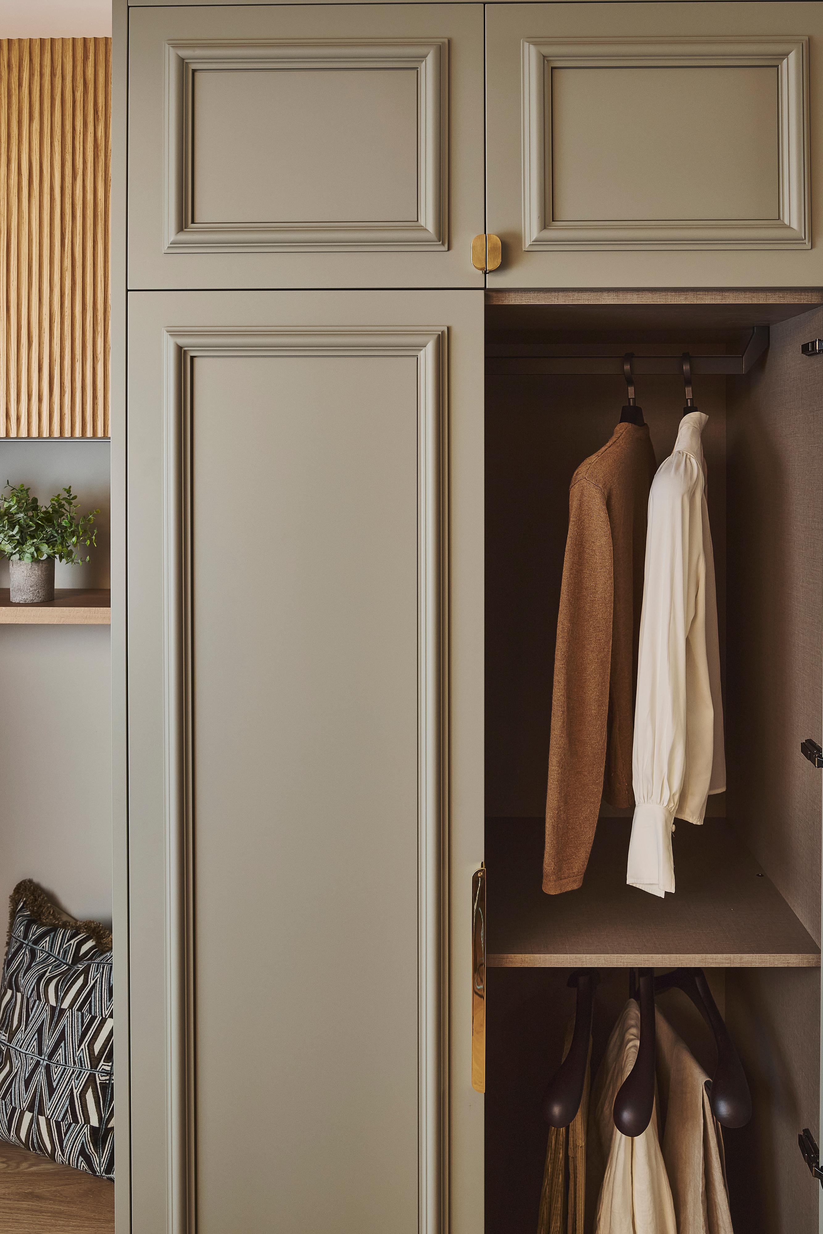A close-up of a wardrobe painted in Burnham Green with Armac Martin Handle