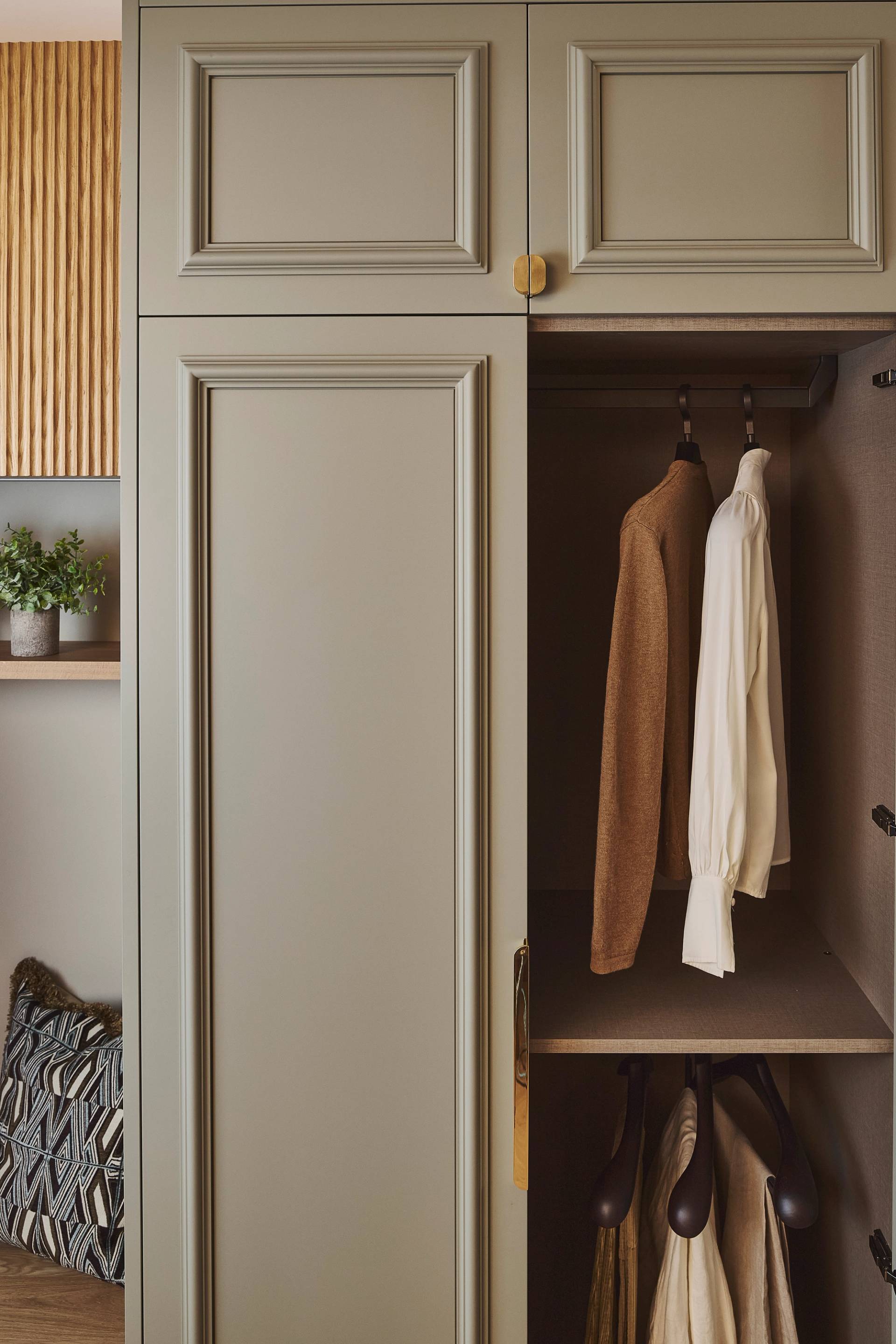 A close-up of a wardrobe painted in Burnham Green with Armac Martin Handle