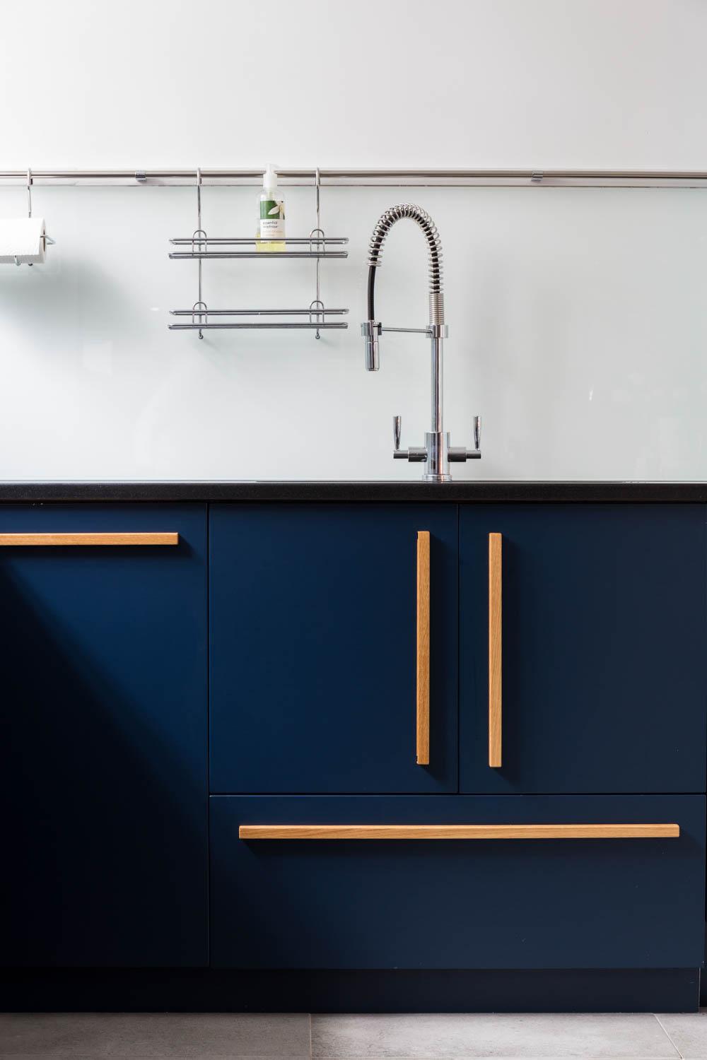 Stainless steel appliances blend seamlessly with sleek dark countertops, amplifying the minimalist aesthetic and modern vibe.