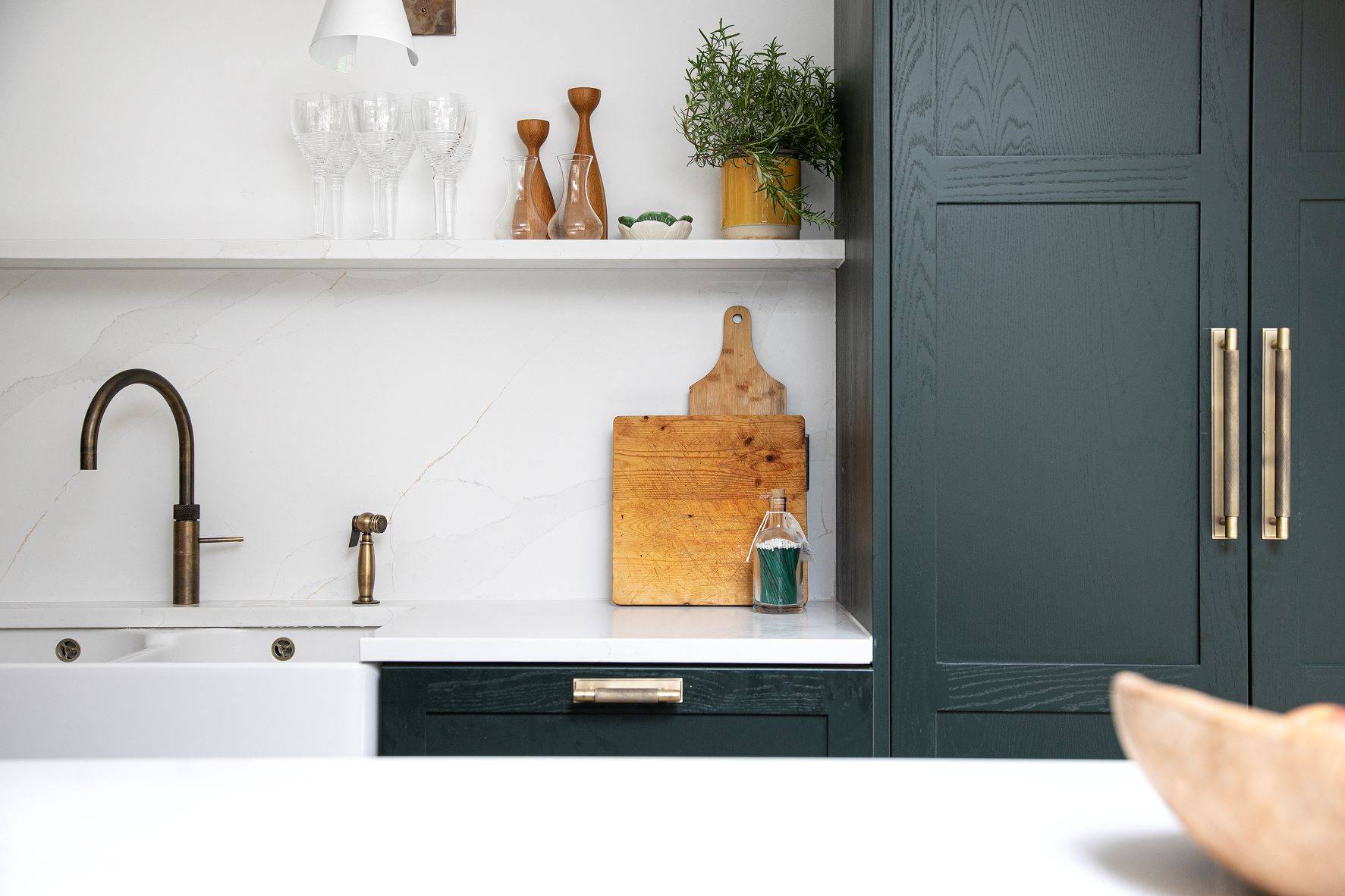 A glimpse into the Westward Ho kitchen, showcasing the interplay of Sandringham Pine cabinetry, a modern white backdrop. featuring a combination of High-end appliances, transforming the Westward Ho kitchen into a true chef\'s delight.
