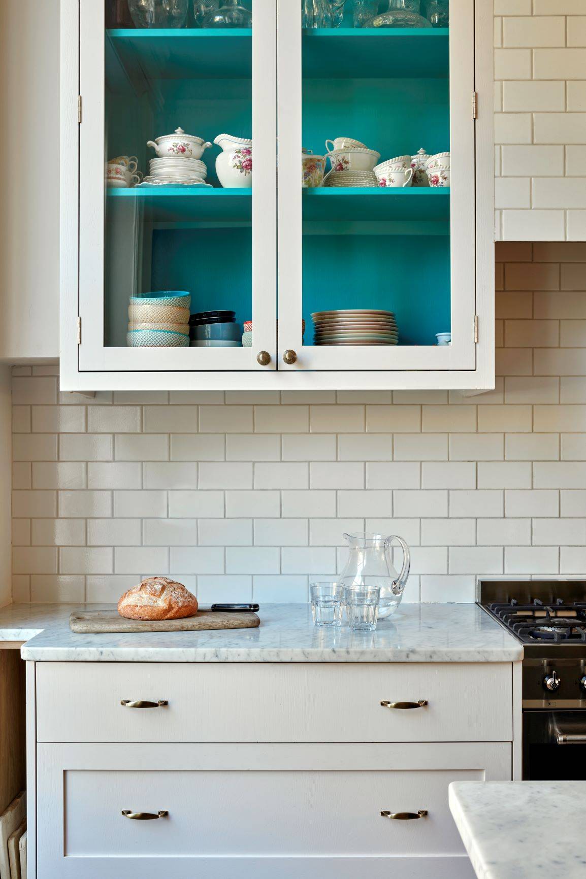 A shaker style kitchen unit with brass handles and white quartz worktop and a glazed shaker wall unit is a classic and timeless combination that never goes out of style. The shaker style cabinets are known for their clean lines and simple, elegant design, while the brass handles add a touch of luxury and sophistication.