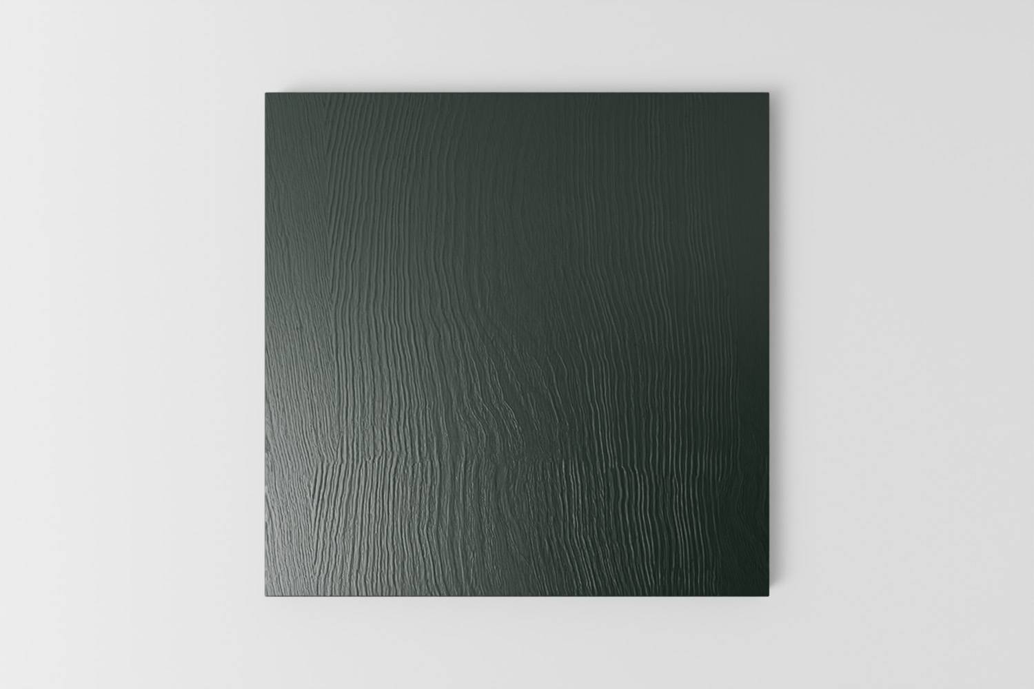 Picture of a square sample painted with a visible grain in Naked Kitchen's Sandringham Pine dark green colour