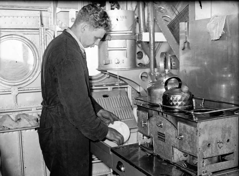 Crew member washing up mid-flight in the galley kitchen of a Sunderland Mk I flying boat,