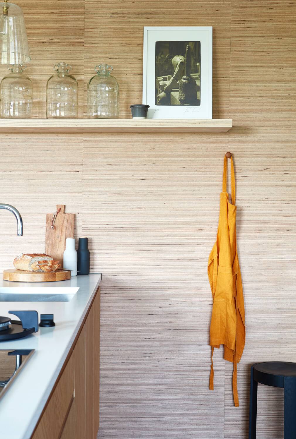 A stylish floating shelf adds visual interest and provides additional storage space, complementing the minimalist aesthetic.