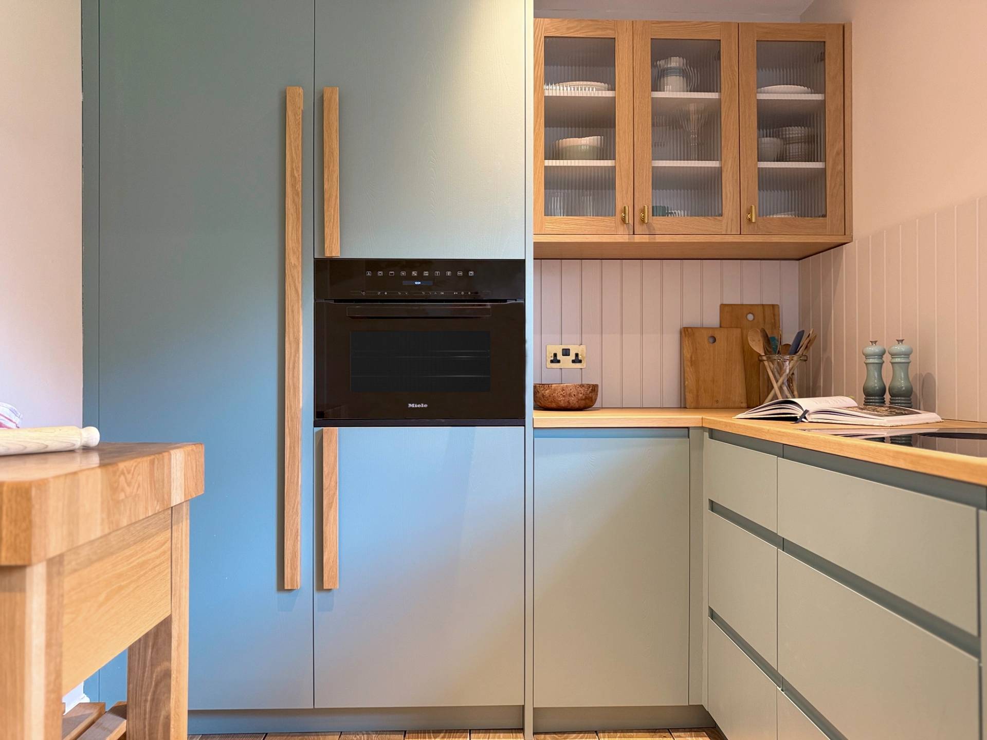 walnut island in green and walnut kitchen