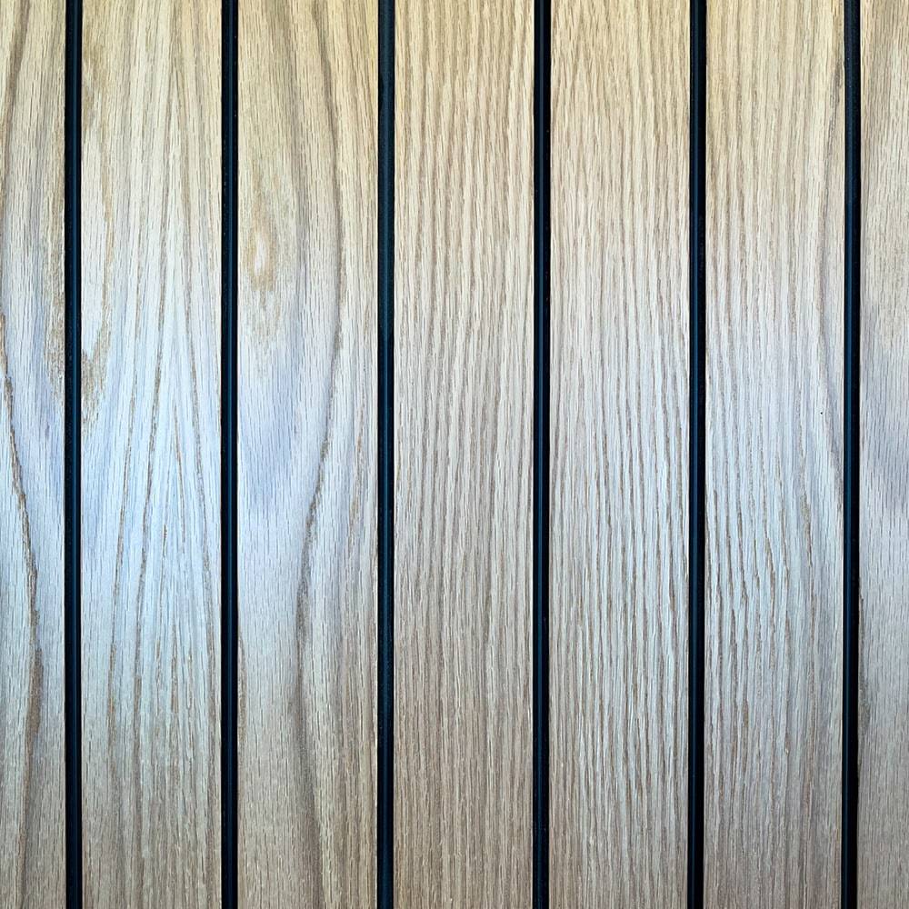 Close-up of vertical wooden panels with visible grain patterns, separated by thin dark lines. The wood is light brown and the image shows a repetitive, symmetrical arrangement.