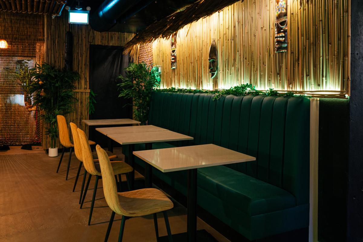 Lush banquette seating with layered tropical details