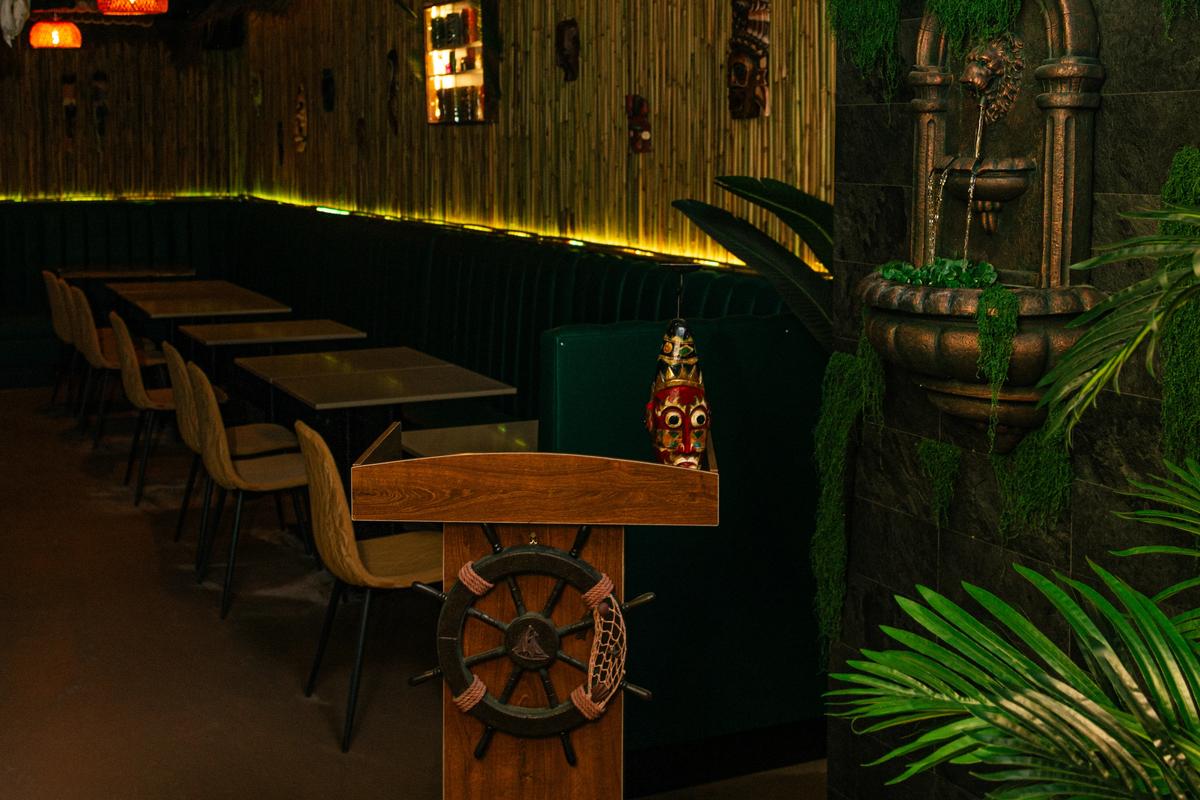 Tiki-inspired seating and custom decor inside Jungle Bird Tiki Lounge in Calgary