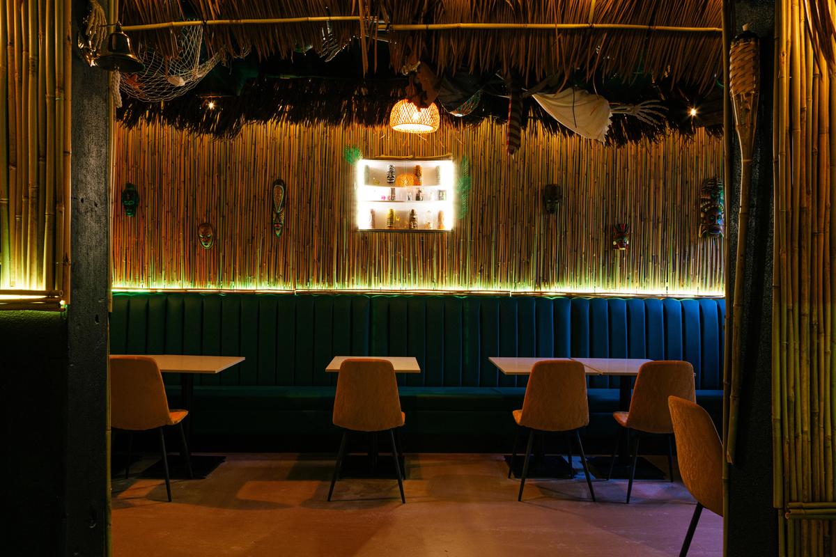 Classic tiki lounge seating beneath handcrafted decor