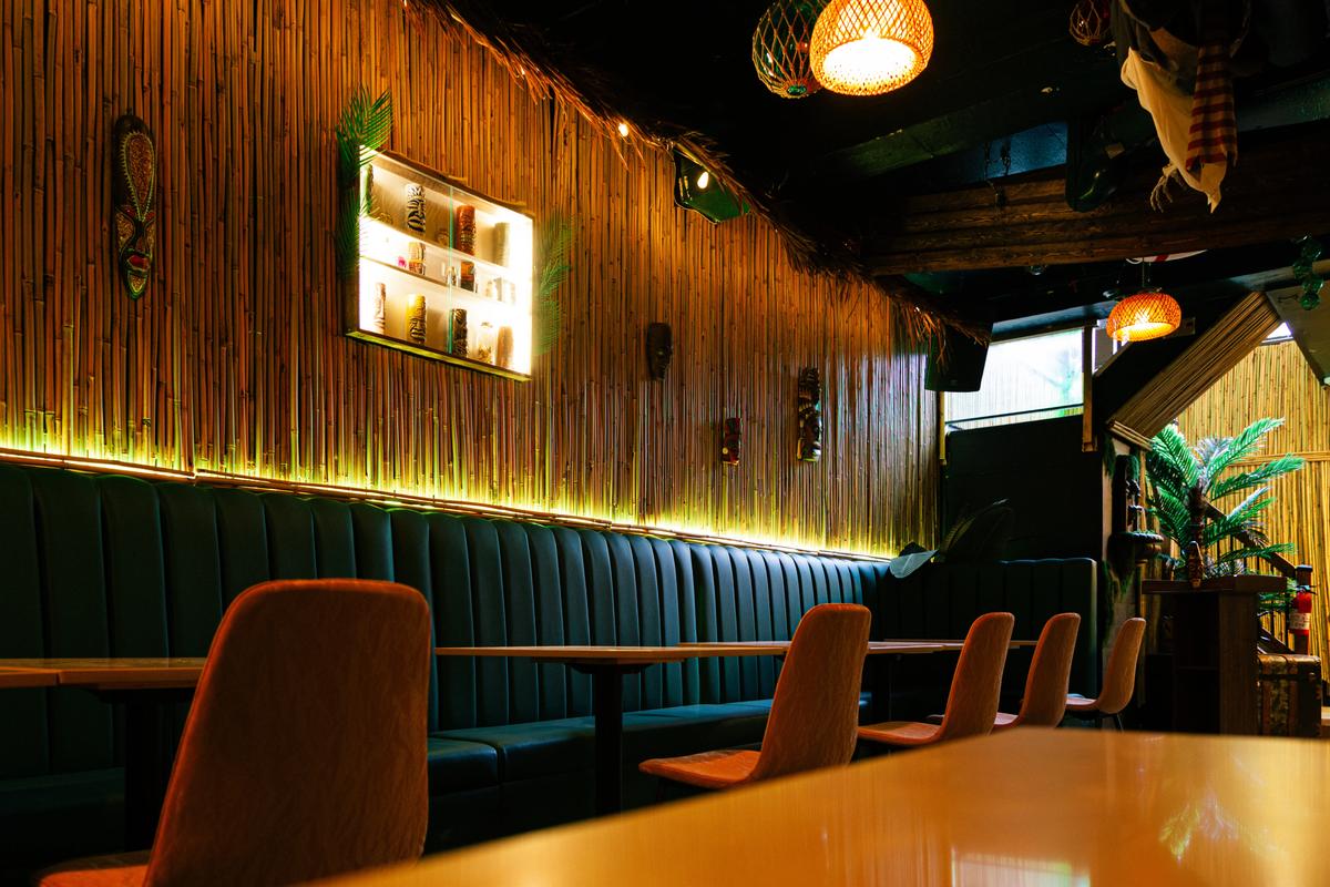 Cozy banquette seating with bamboo walls at Jungle Bird Tiki Lounge Calgary