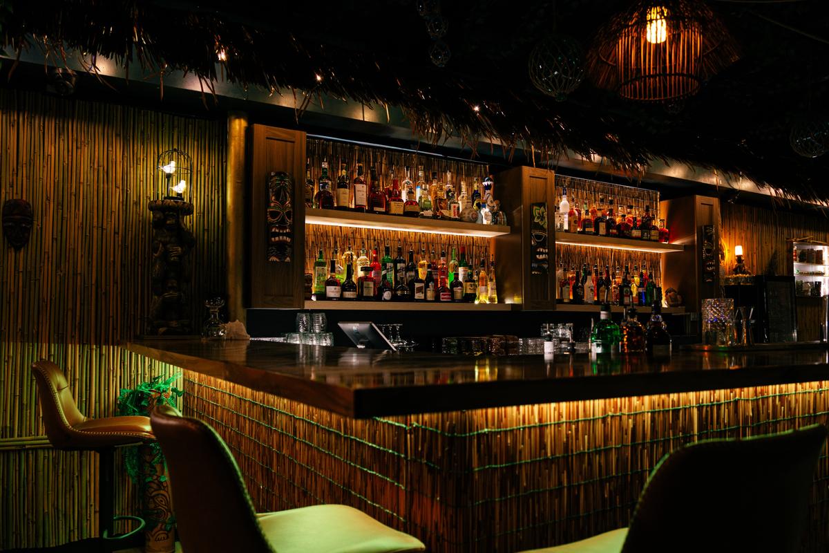 The main bar at Jungle Bird, lined with an extensive rum collection