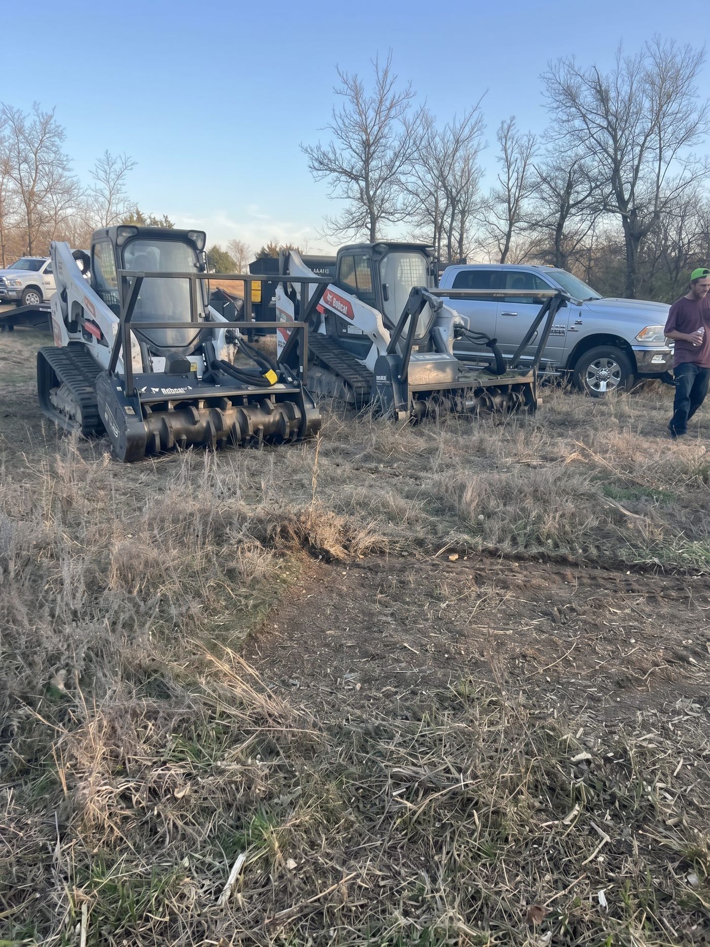 Track loaders with mulcher heads in the brush