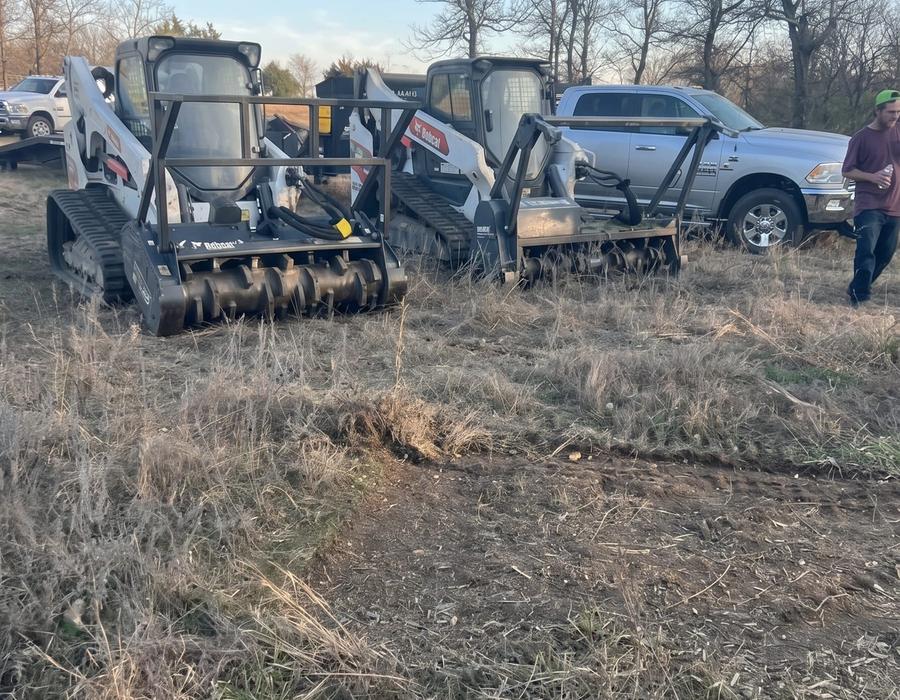 Track loaders with mulcher heads in the brush