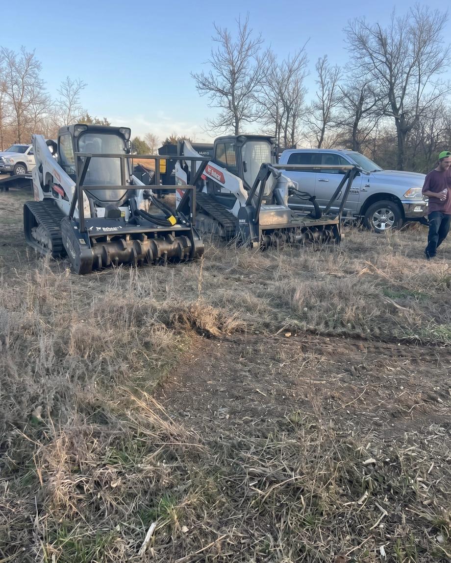 Track loaders with mulcher heads in the brush