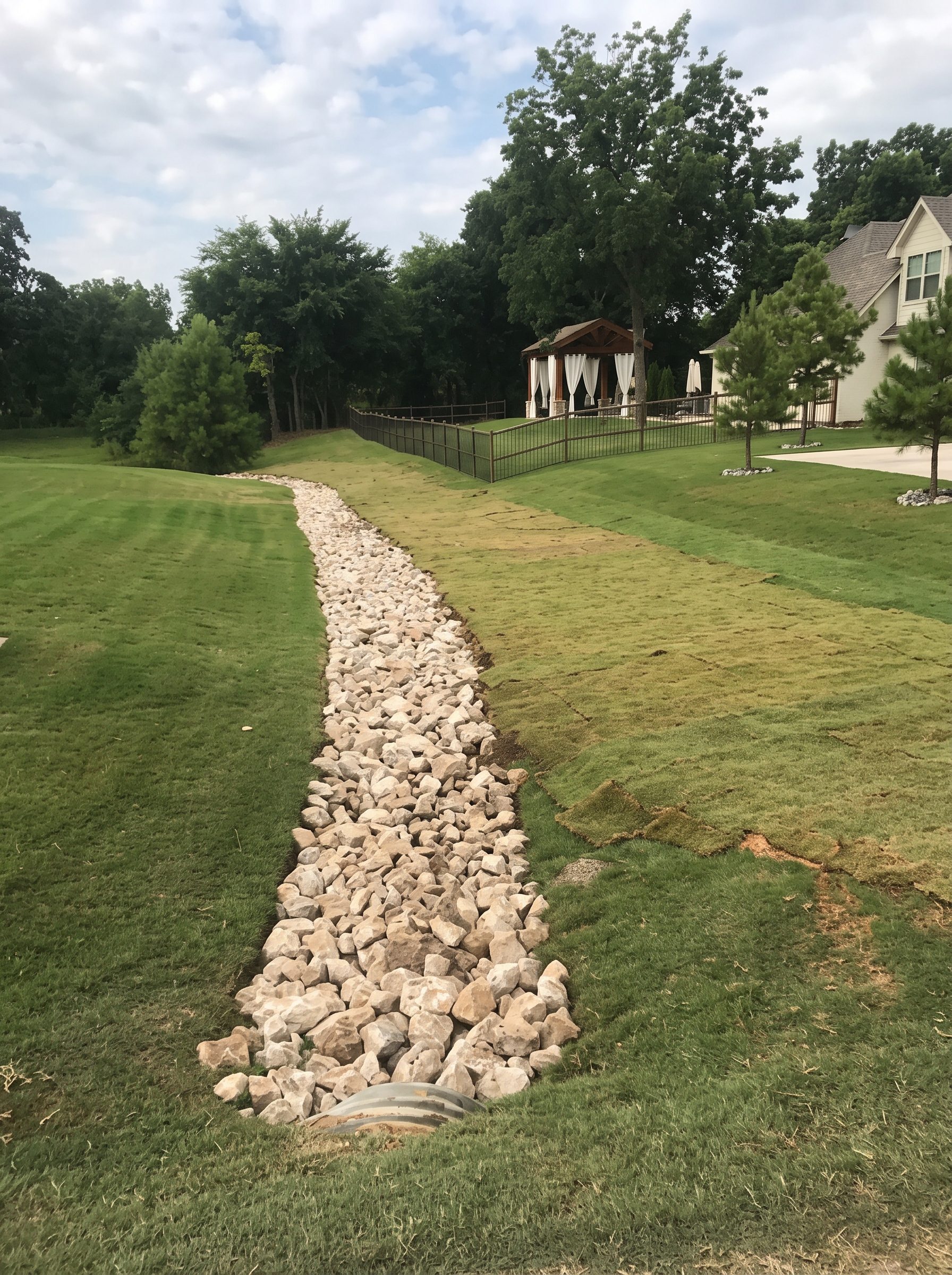Dry creek bed through a rebuilt lawn