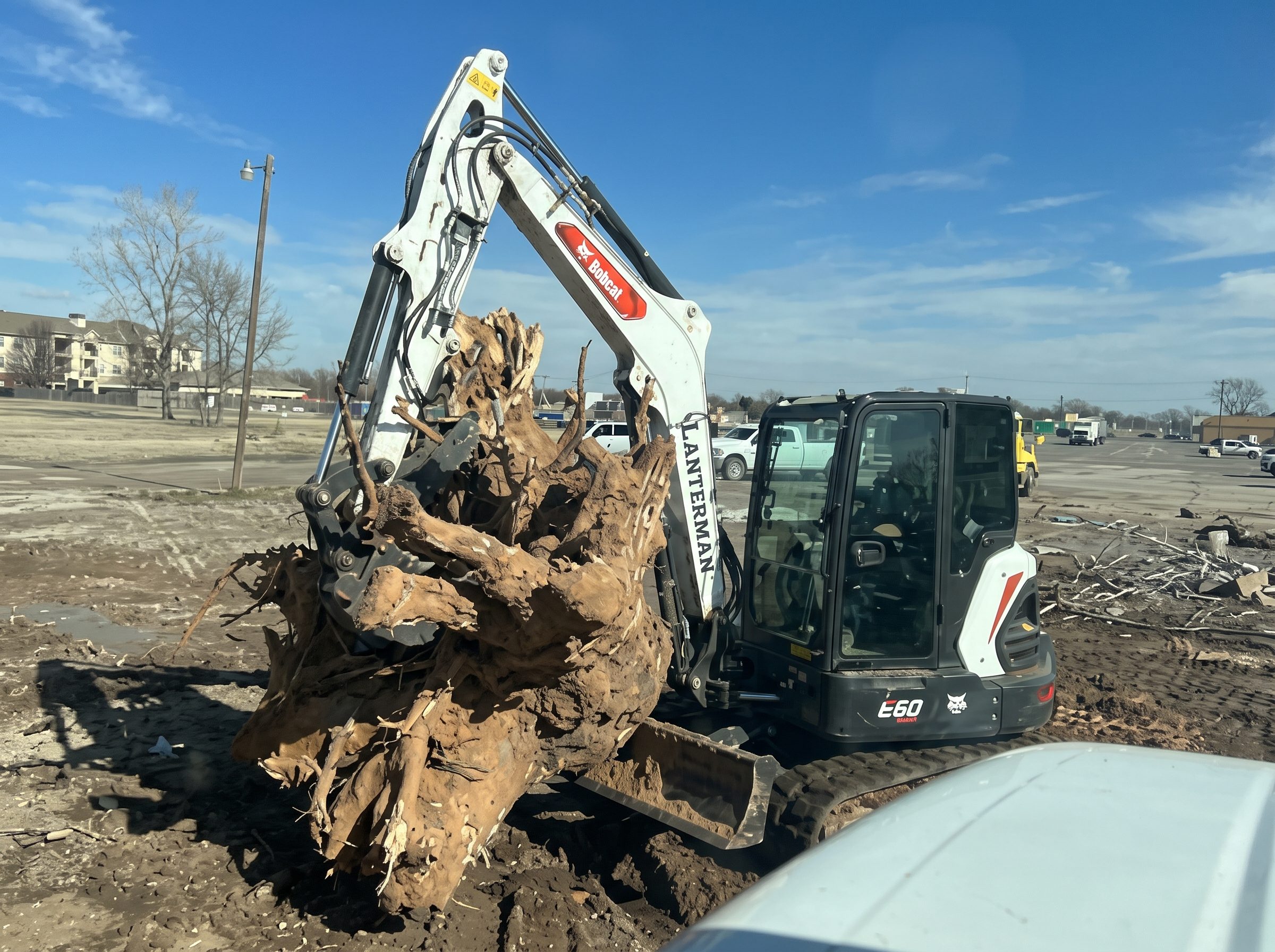 Excavator pulling a stump