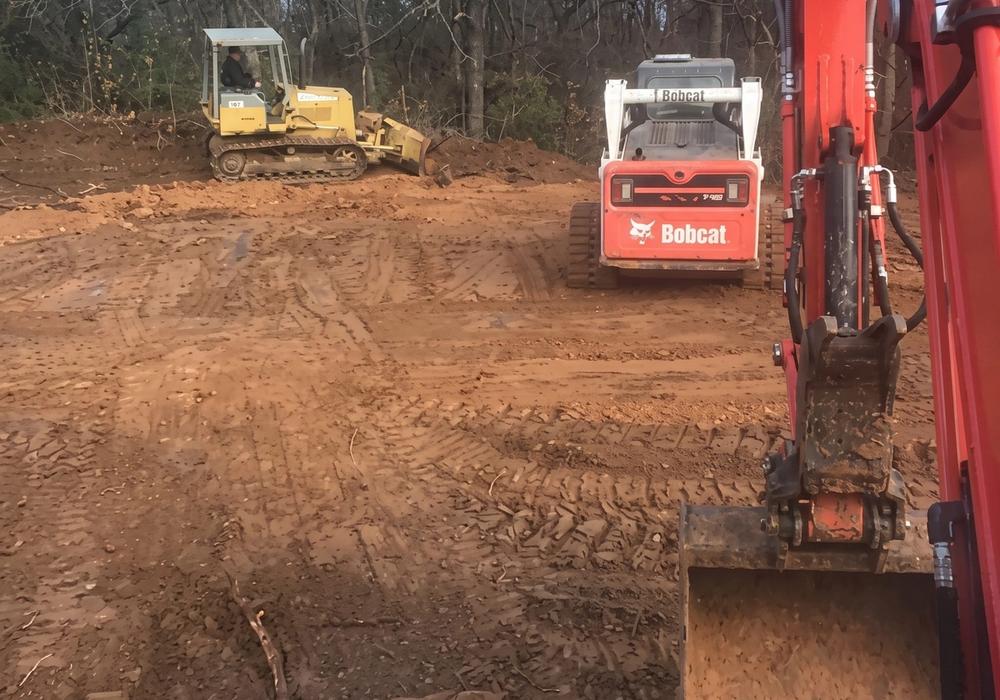 Excavator on a freshly cleared lot