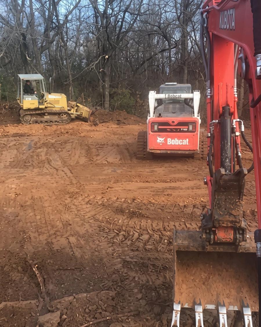 Excavator on a freshly cleared lot