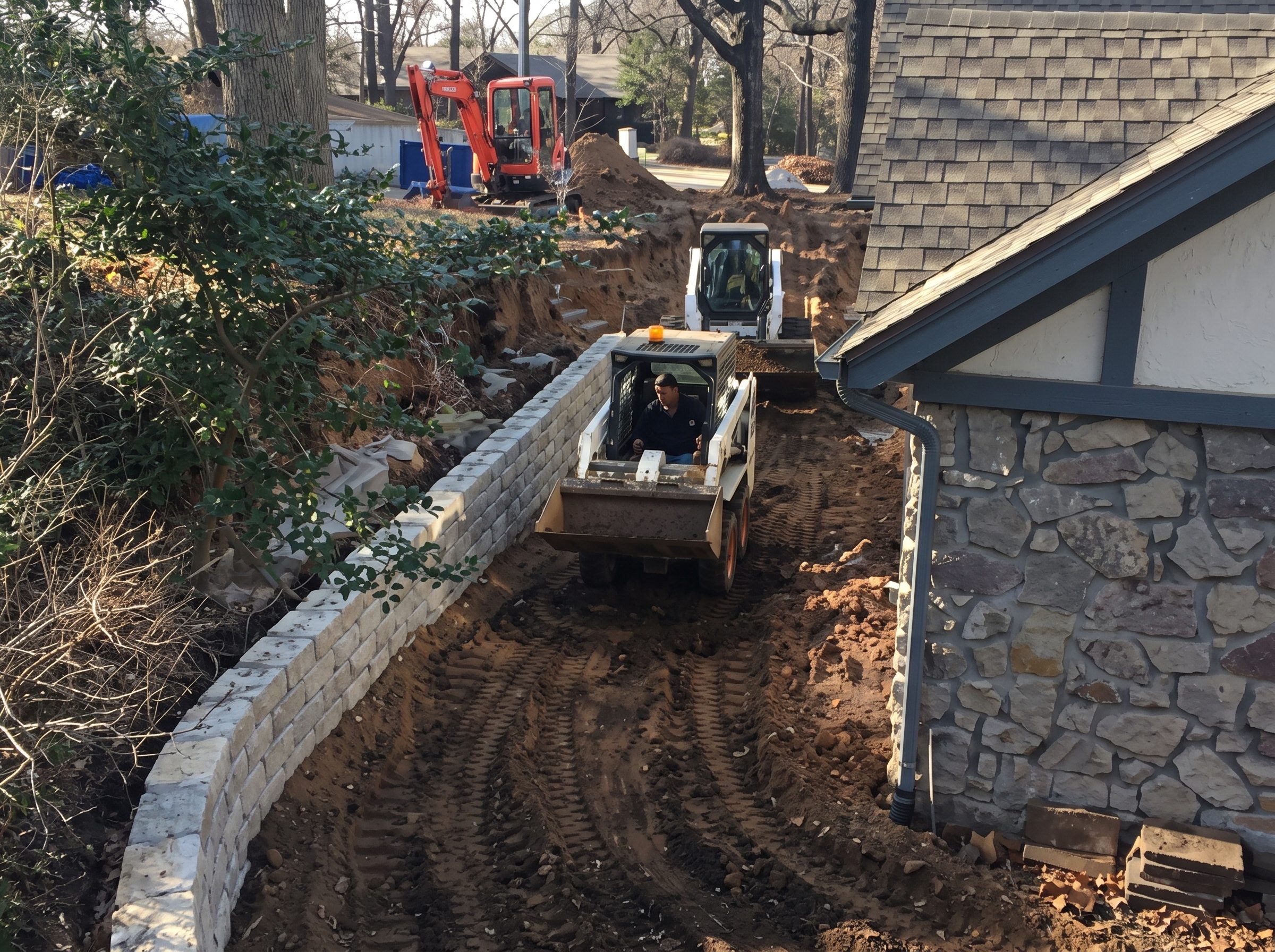 Stone wall and beds along a new grade