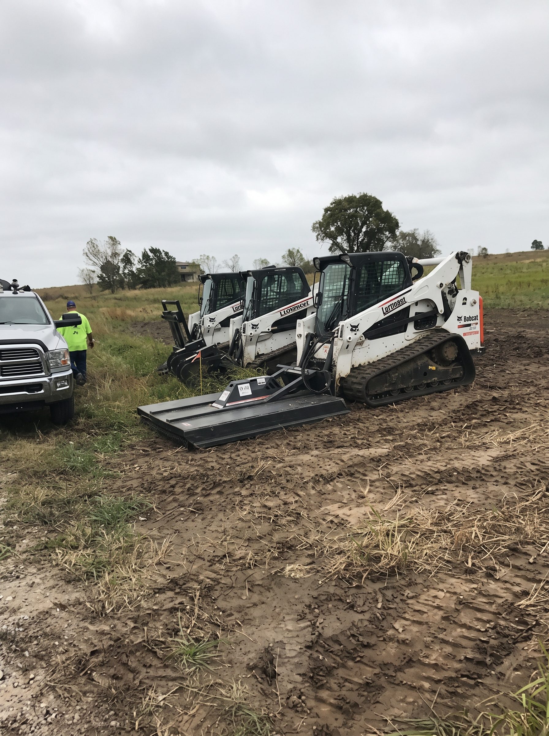 Tractor grading a pad site