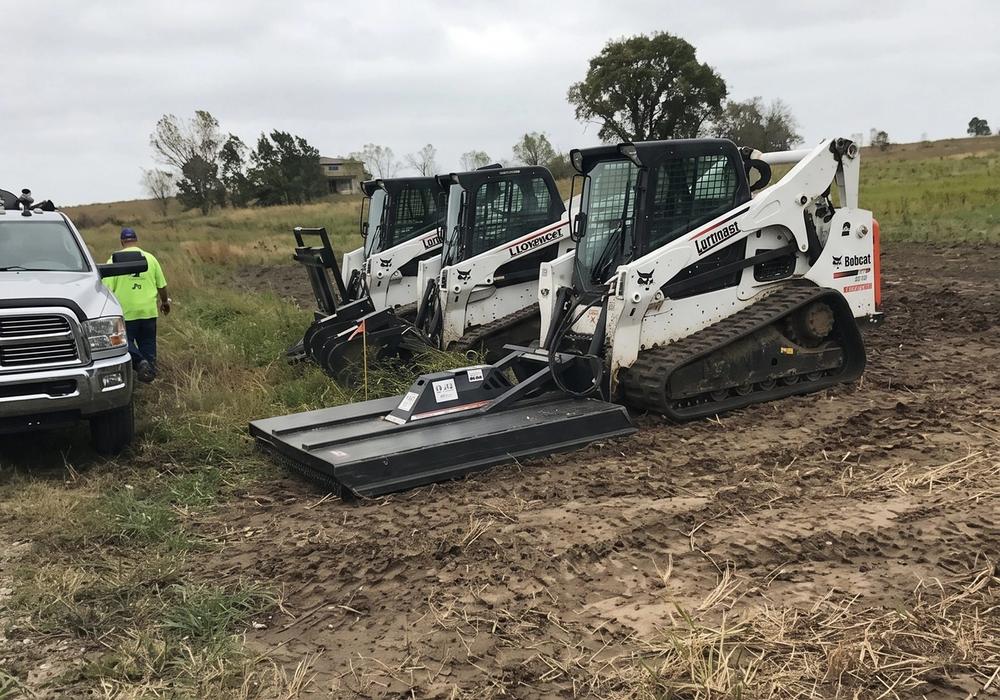 Tractor grading a pad site