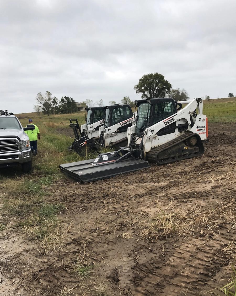 Tractor grading a pad site