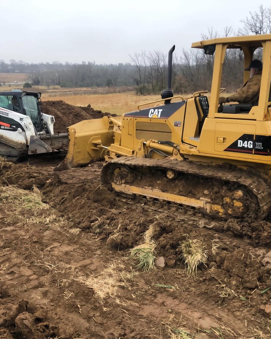 A CAT dozer and track loader clearing a site